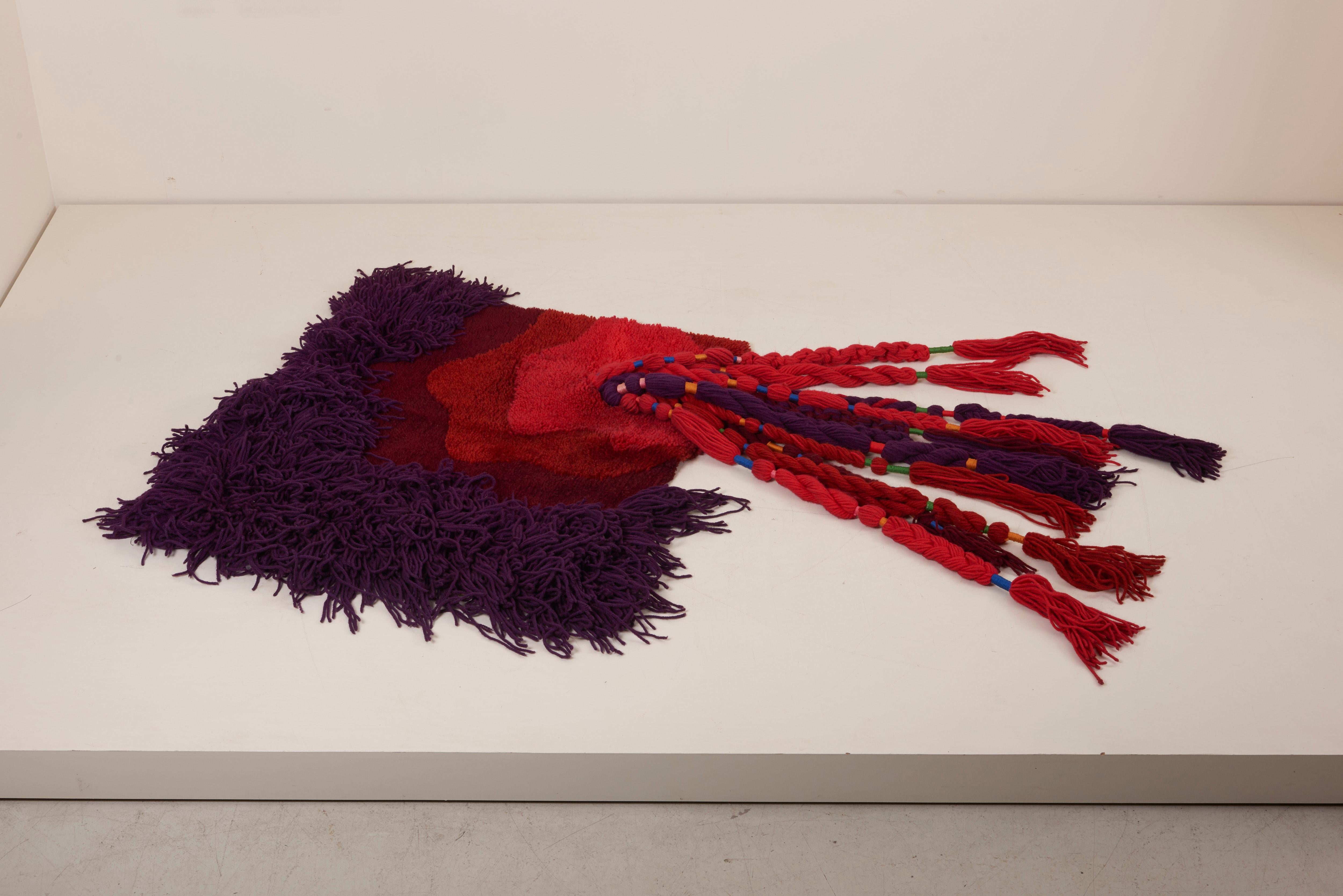 Ewald Kröner designed woollen wall hanging.
An example of the Pop art movement of the early 1970s.
It features wool tassel hanging loosely with tied bands.