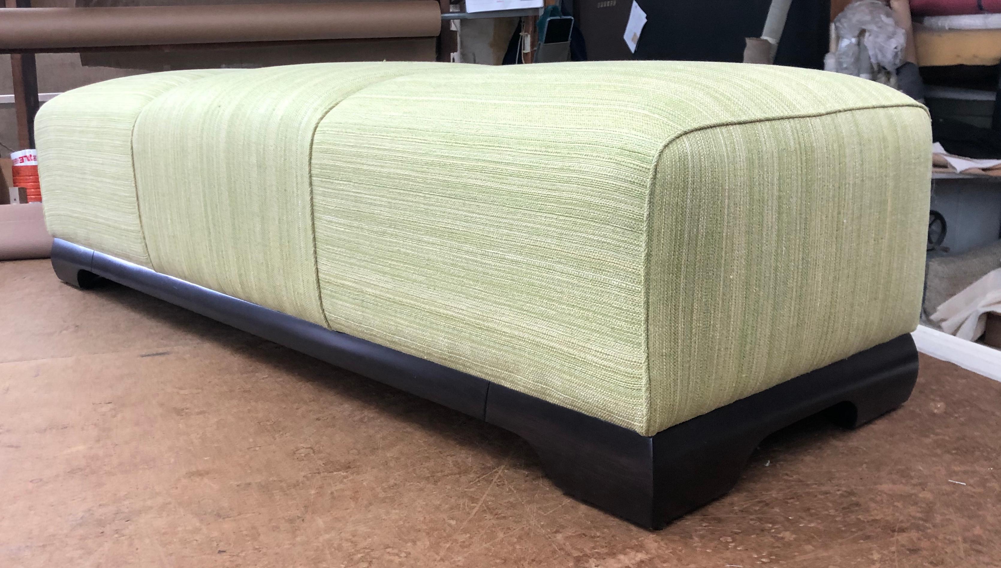 Artfully detailed bench in an apple green and white striae fabric on a dark walnut base.