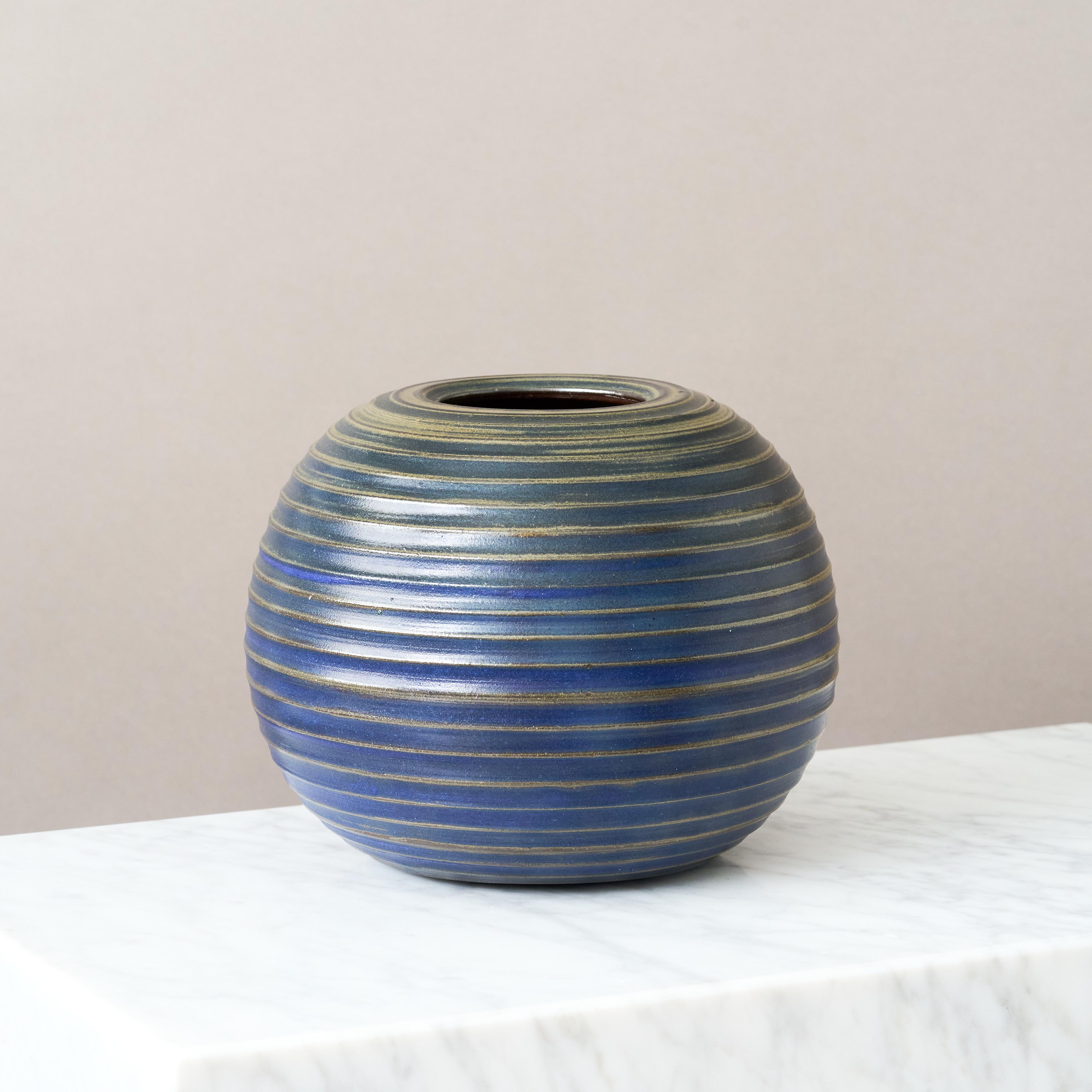 A rare and beautiful stoneware globe vase with amazing blue glaze. 
Made by Arthur Andersson for Wallakra, Sweden, 1950s

Great condition. 
Signed 'AWA'.

Arthur Andersson was one of Sweden’s leading ceramic artists in the 20th century. After his