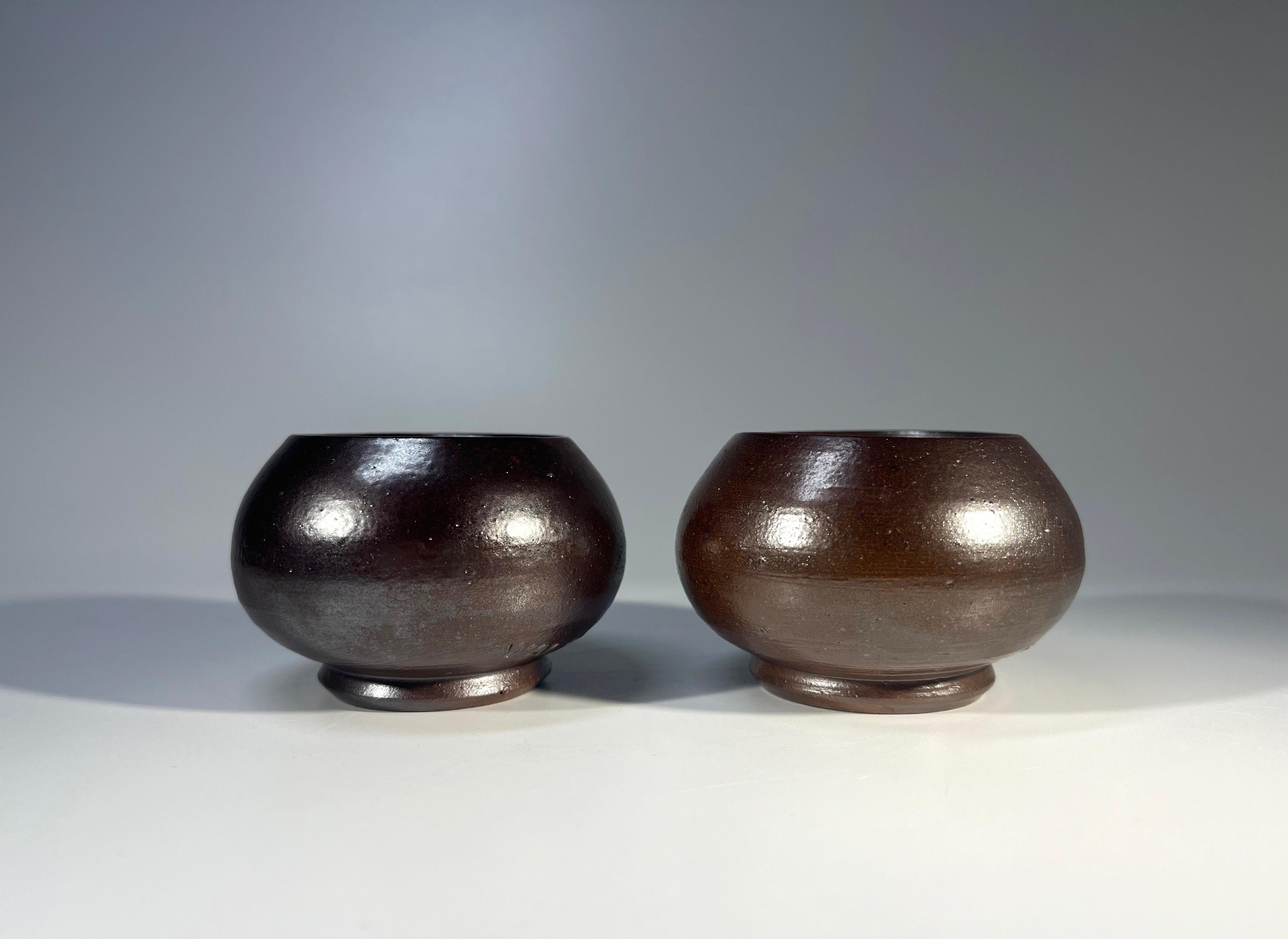A fine pair of stoneware tea light holders by Arthur Andersson for Wallåkra of Sweden
Simplified design with a potent dark brown glaze. Ageless.
Circa 1950's
Signed Wallåkra to base
Height 1.75 inch, Diameter 2.75 inch
In excellent condition. 
Wear