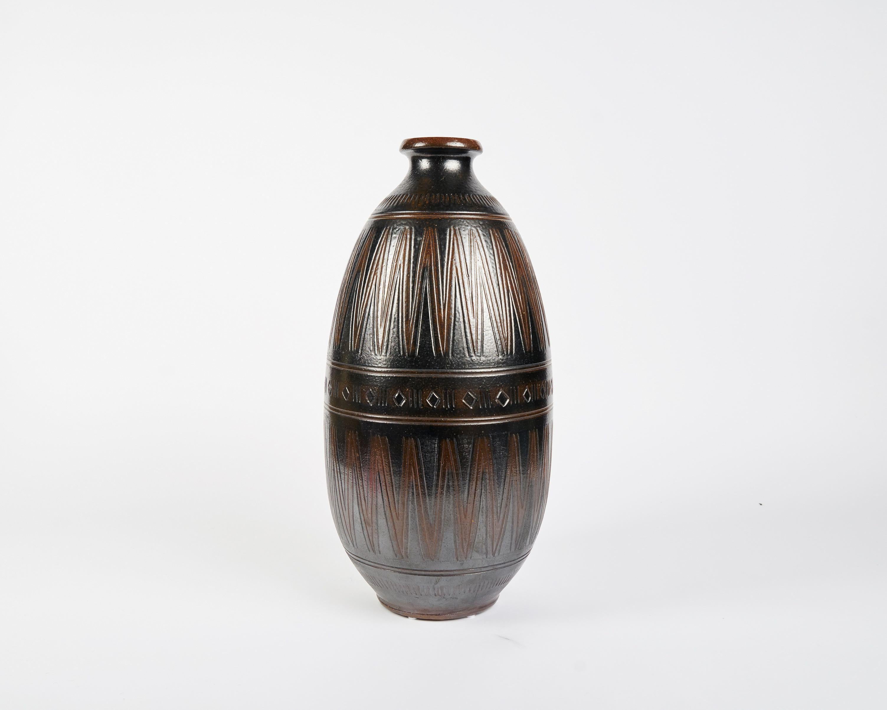 Created by the Swedish ceramist Arthur Andersson in the mid-20th century, these voluminous vases are noteworthy for their formal symmetry and their banded designs, which often run in either horizontal or vertical patterns of zig zags, striations, or