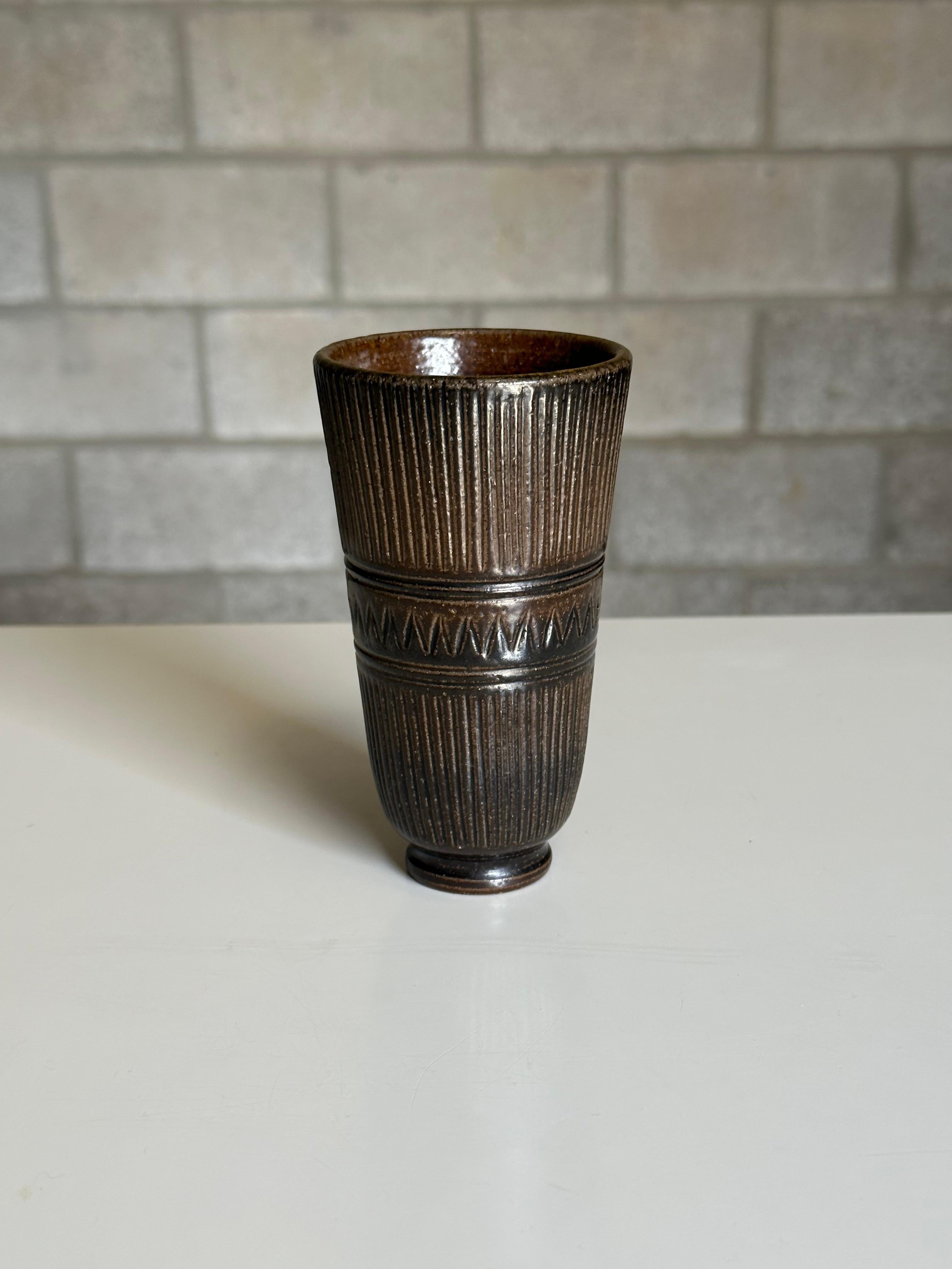 A stoneware vase designed by Arthur Andersson for Wallåkra, circa 1950s. Features an exciting black and brown dark glaze with heavy incision pattern. Very heavy well made piece.