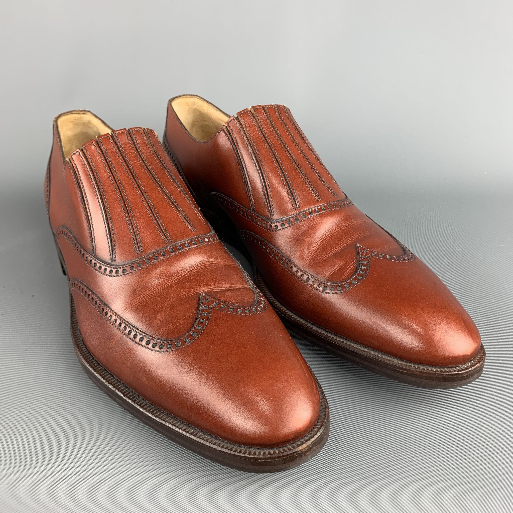 ARTHUR BEREN for GRAVATI loafers comes in a brown perforated leather featuring a wingtip style and a wooden sole. Made in Italy.
 
Excellent Pre-Owned Condition.
Marked:11
 
Measurements:
 
Outsole: 13 in. x 4.75 in.