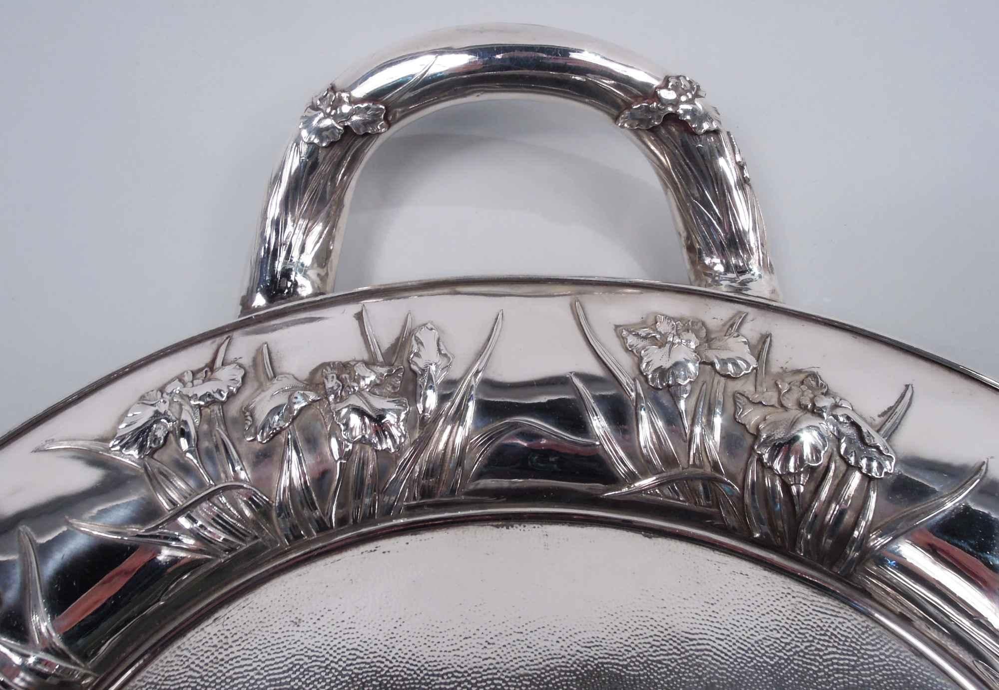Japanese Meiji Art Nouveau silver tea tray, ca 1890. Retailed by Arthur & Bond in Yokohama. Lobed oval. Well stippled and engraved with shaded interlaced monogram. Upturned c-scroll end handles. Blossoming prunus branches, iris flowers, and bamboo
