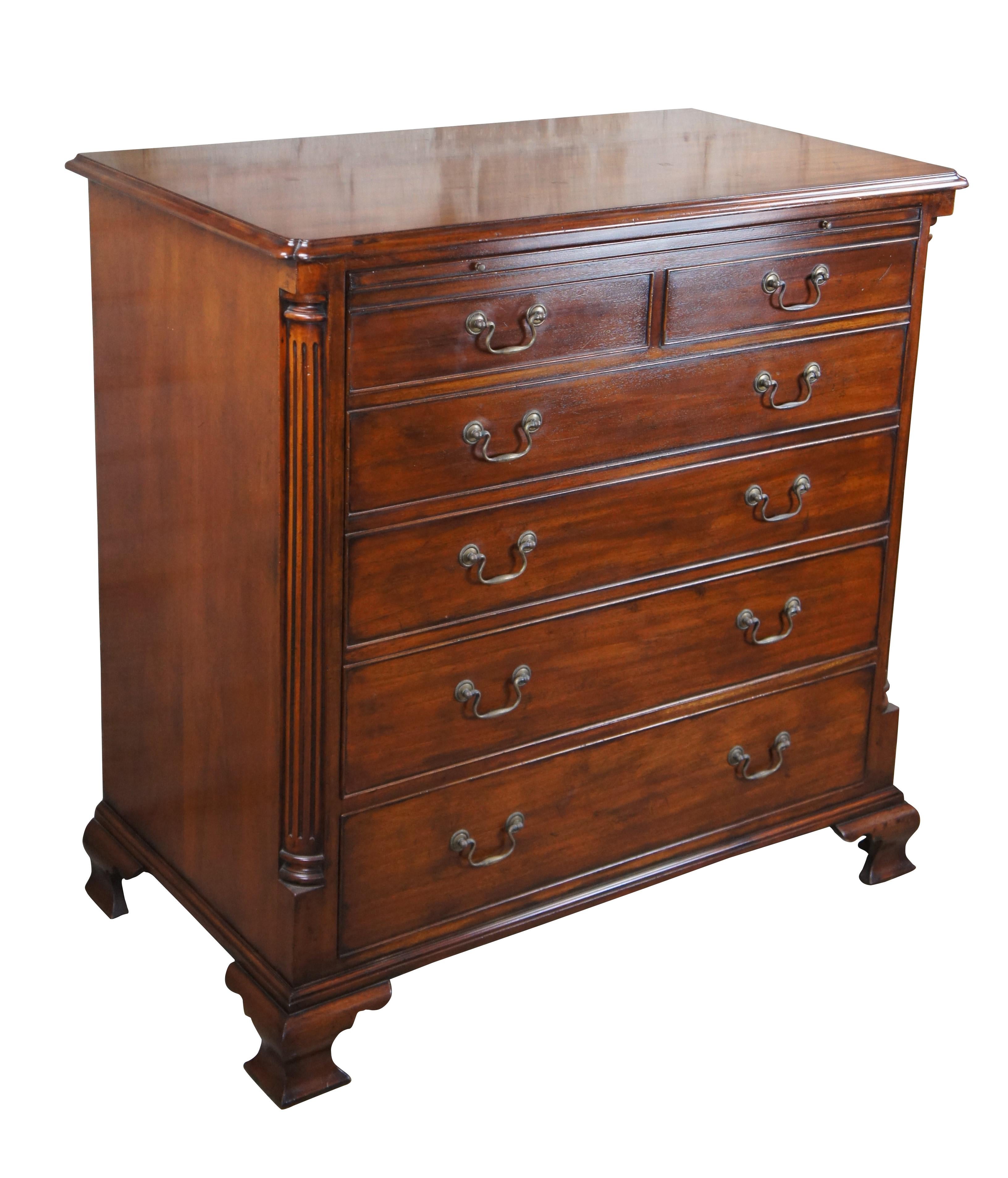 An exquisite 18th Century reproduction in the form of a mahogany bachelors chest by Arthur Brett. Features a faux 2 over 4 drawer graduated design which draws forward and slides back to reveal an interior compartment intended for a television.