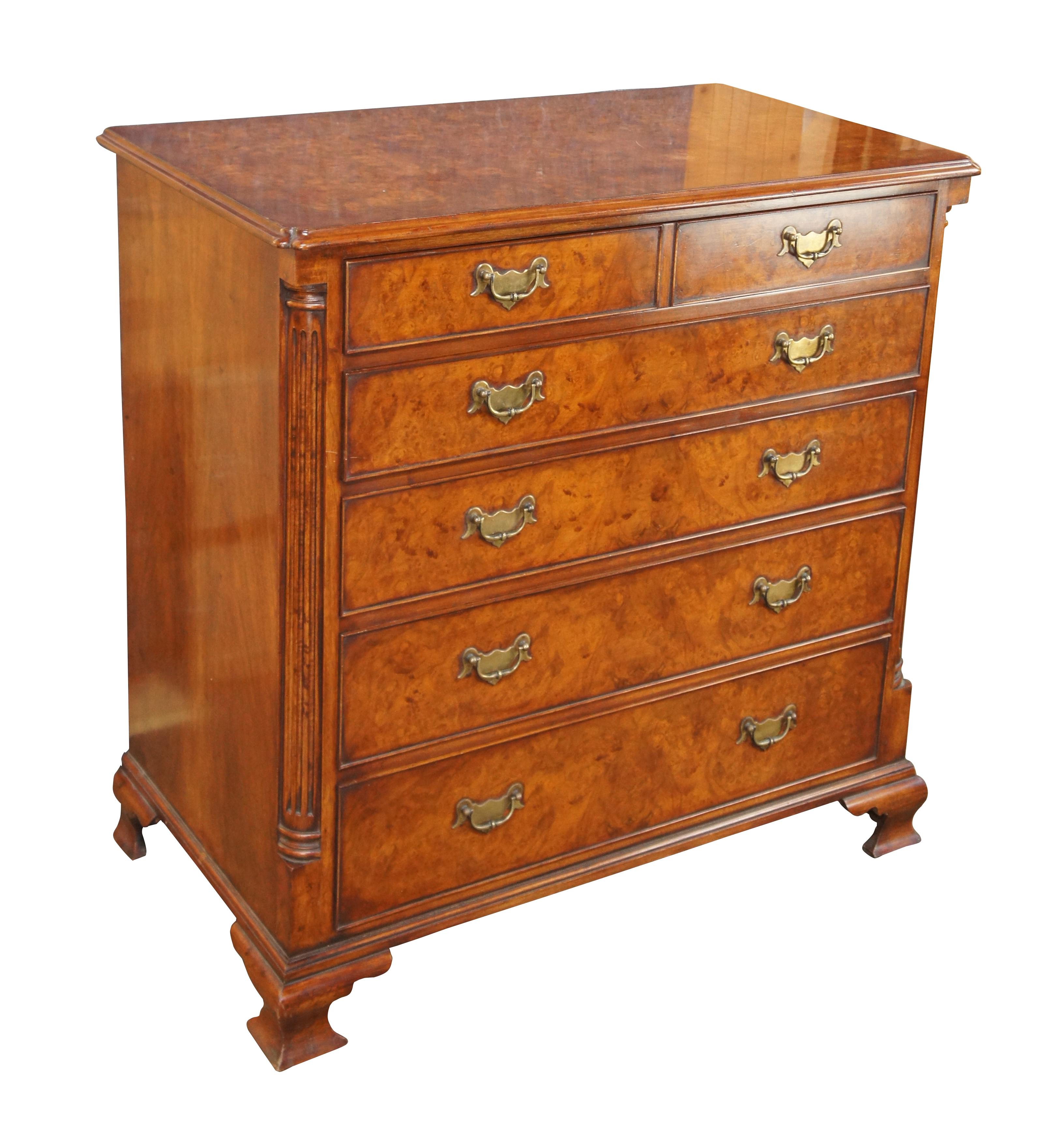 An exquisite 18th Century reproduction bachelors chest by Arthur Brett & Sons. Made from mahogany with burled front and top. Features a 2 over 4 drawer graduated design. Drawers are constructed from oak with dovetailing and colonial brass batwing