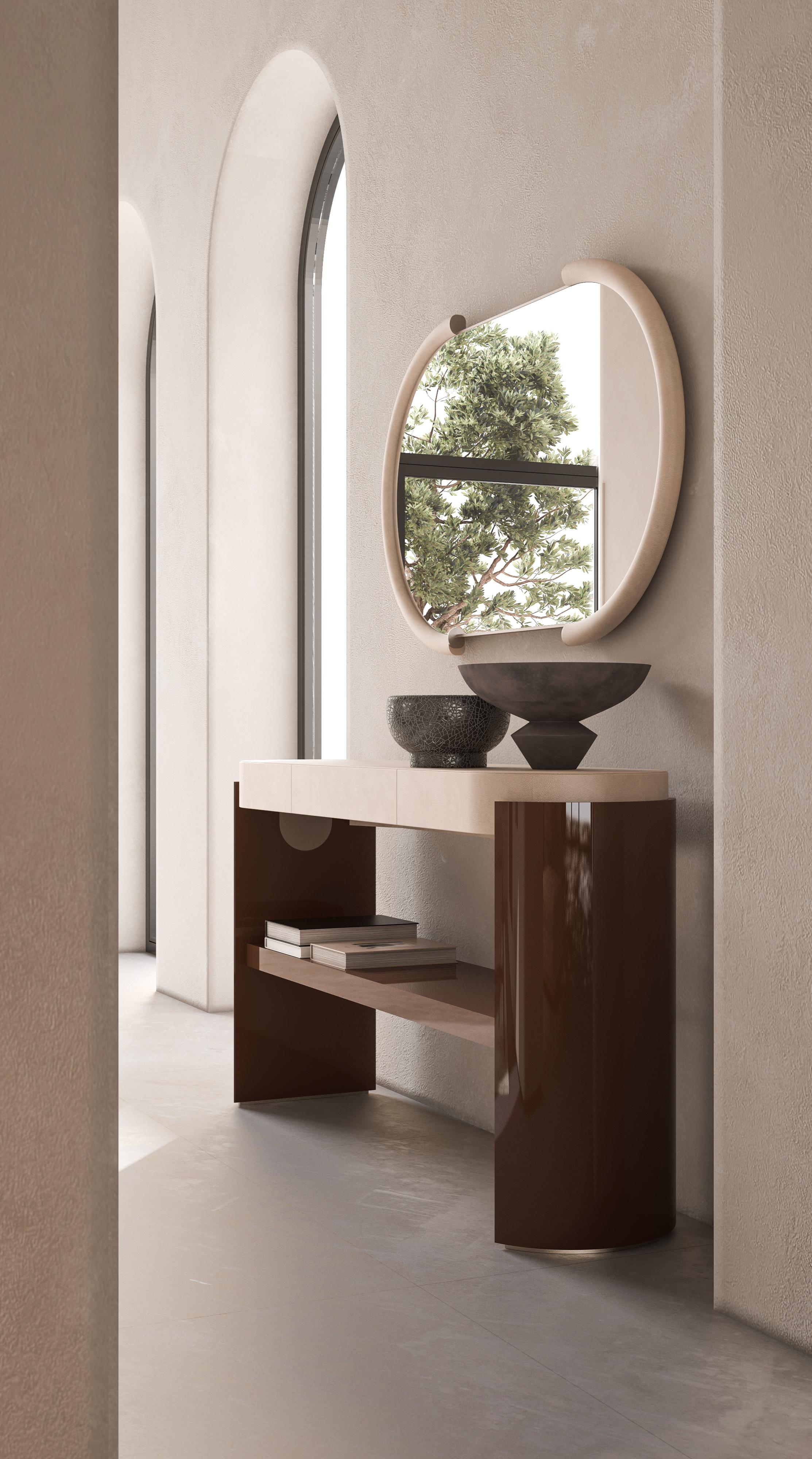 This refined console table features a sleek lacquered structure paired with a luxurious leather-wrapped top. Its sophisticated design blends elegance with modern aesthetics, making it a versatile addition to contemporary interiors. Perfect for