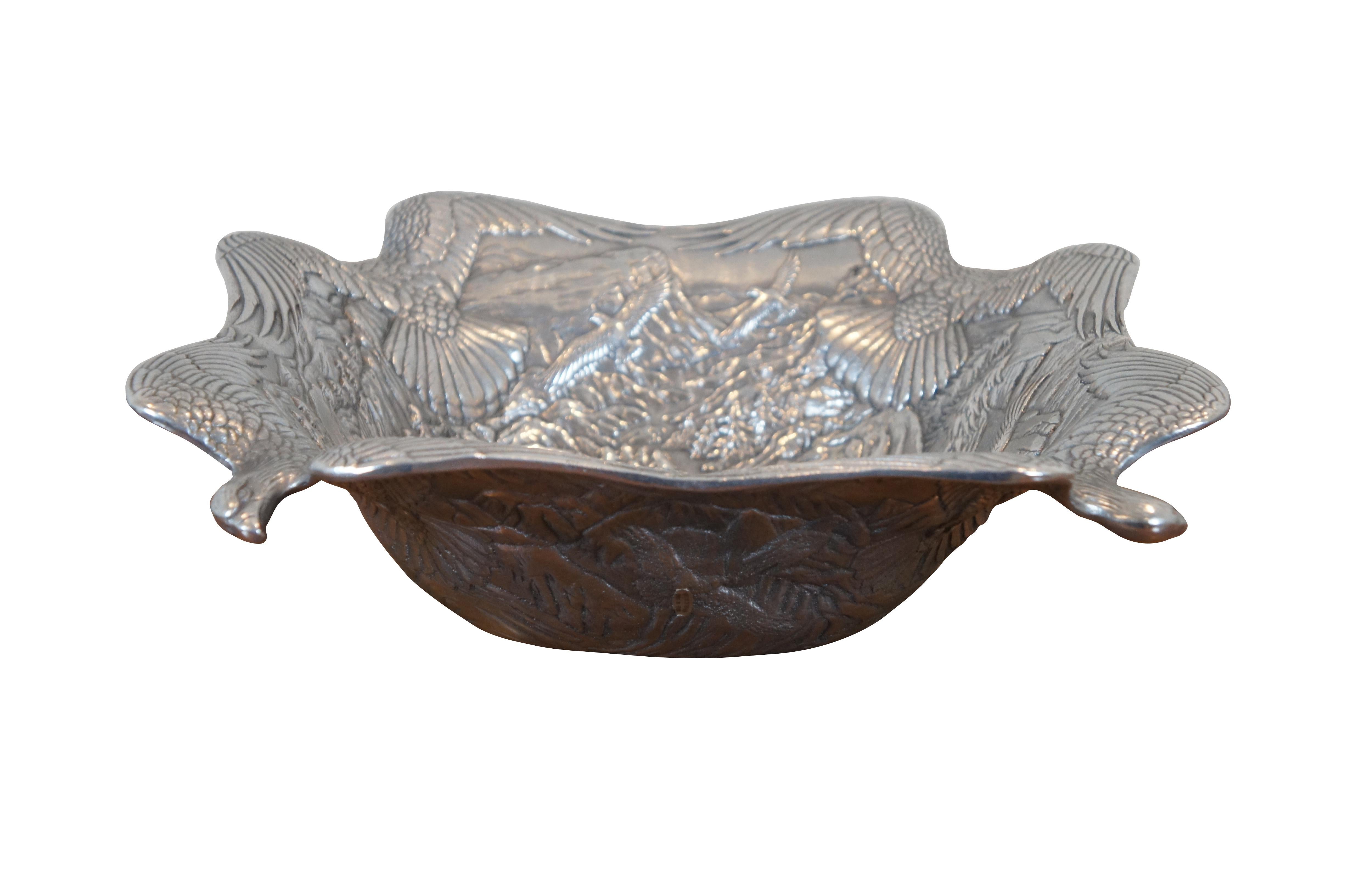 Rare vintage 1992 Arthur Court centerpiece bowl.  Made of aluminum featuring low relief detail of bald eagles soaring / hunting against the mountain landscape.  

Dimensions:
13.25” x 4” (Diameter x Height)