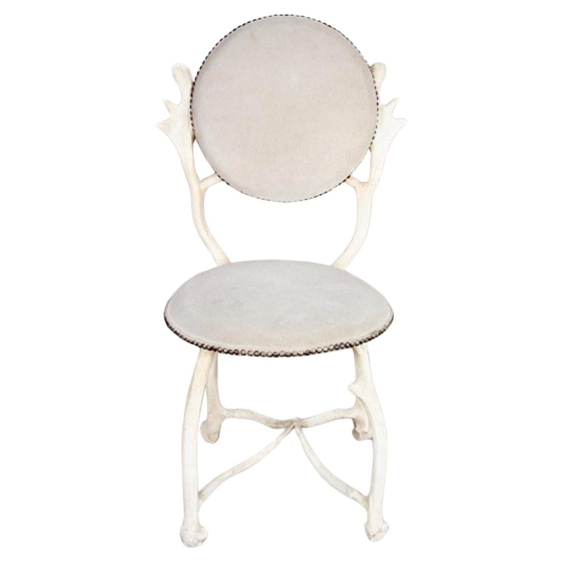 This is a great example of an Arthur Court Antler Chair. The chair dates to the 1970s and is in overall very good original condition with a white painted aluminum faux antler frame and a suede upholstery. The chair shows minor natural patina and is