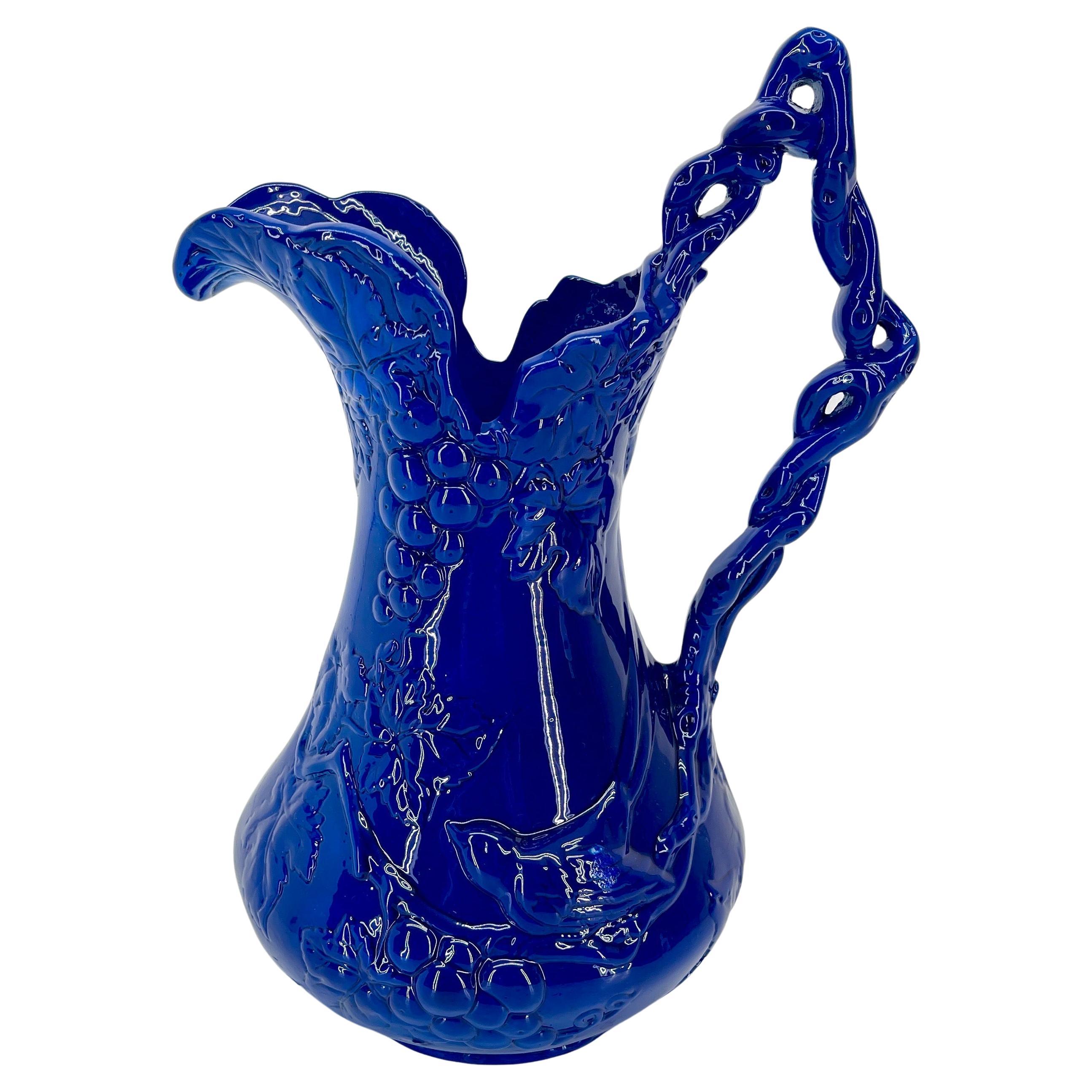 Powder-Coated Bird and Grapevines Blue Sculptured Pitcher from Arthur Court

This one of kind freshly royal blue powder-coated cast aluminum braided handle pitcher with wonderful bird and grape motif. The work of Arthur Court is a constant delight