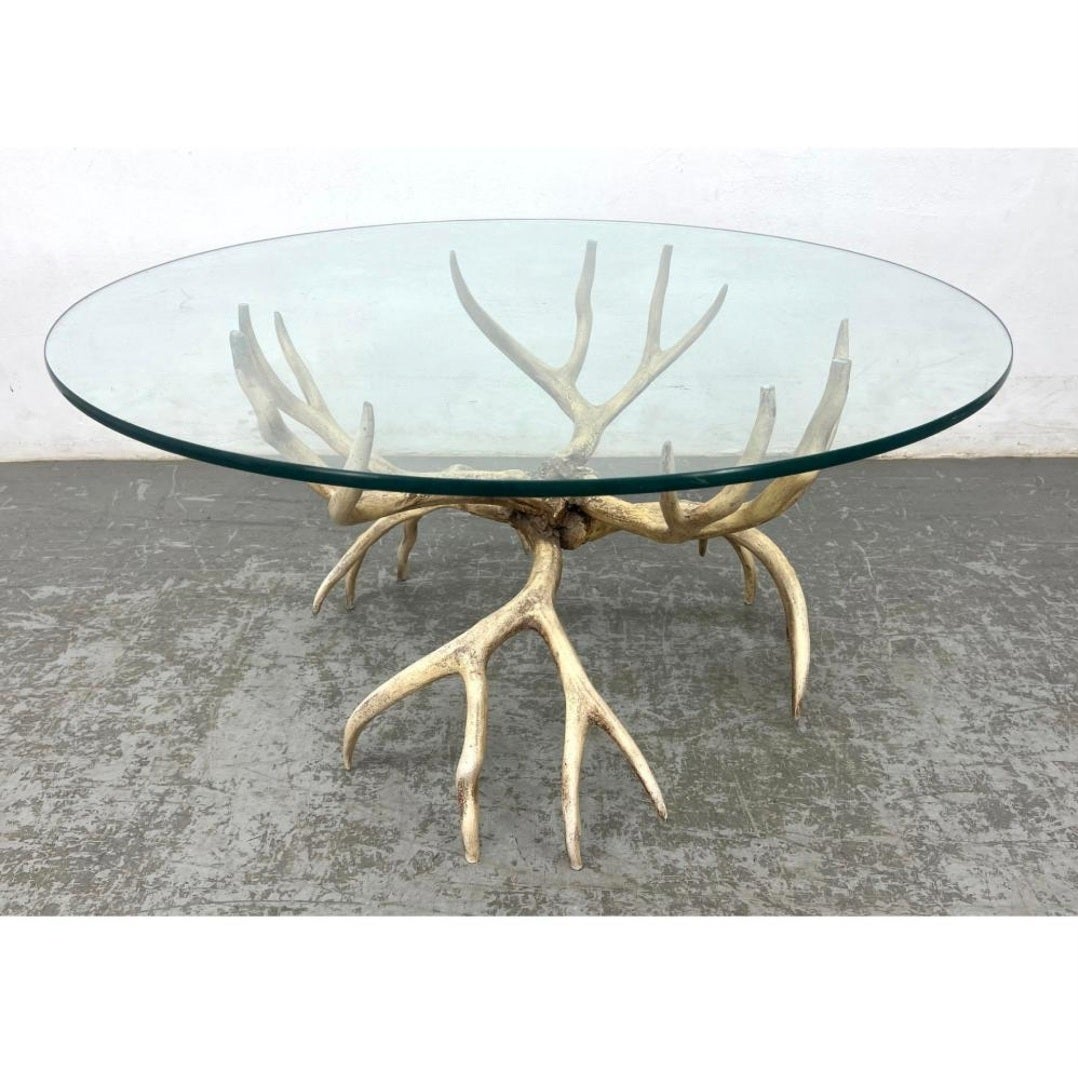 Sexy and whimsical, Arthur Court cocktail table. Made from cast aluminum in antler form, with the original painted faux surface, this table is a statement. Current glass on top is 36 in but could easily hold up to 48. A great piece for any style