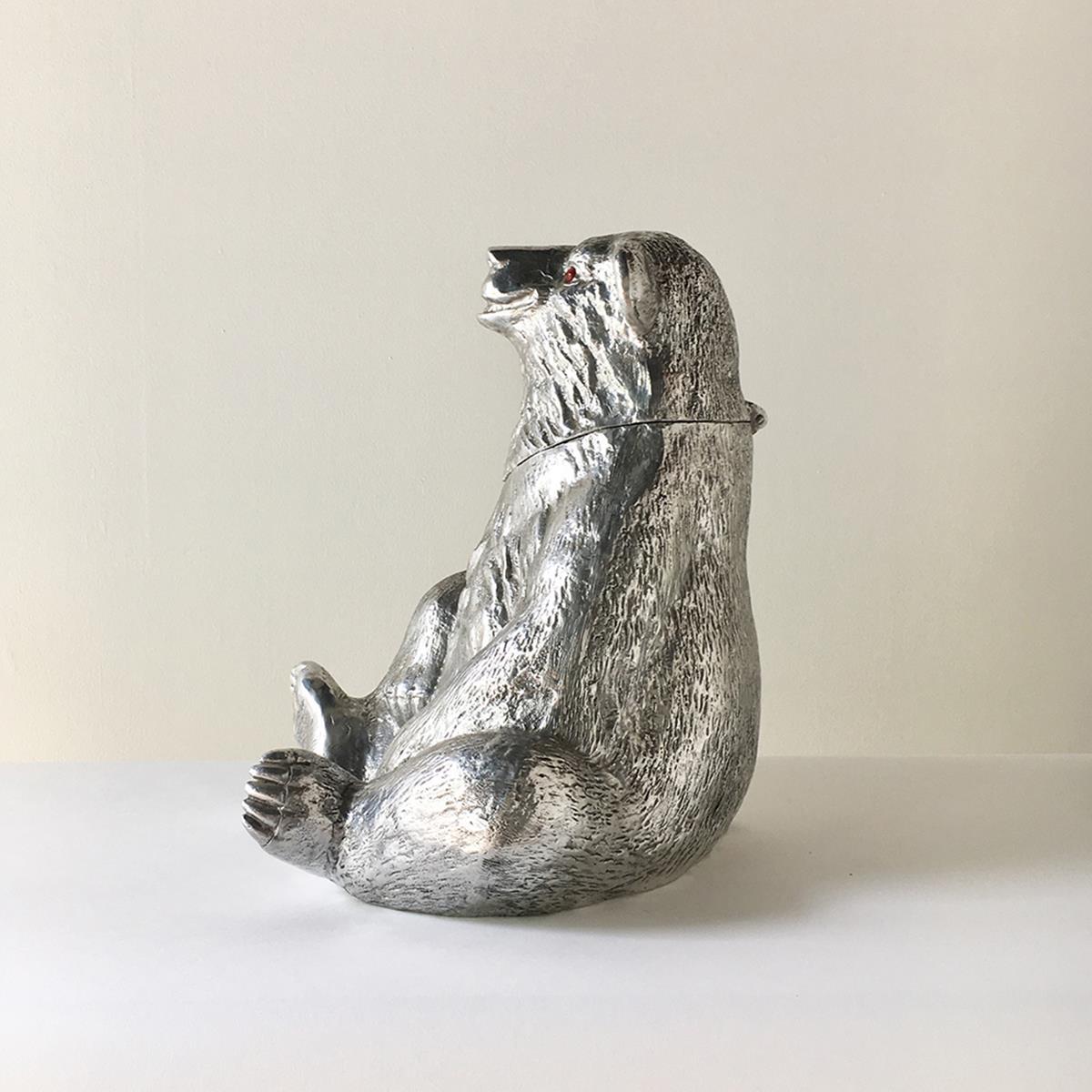Arthur Court designed cast aluminium bear champagne/wine cooler bucket, 1988.
The bears head with carnelian eyes opens on hinges backwards to reveal the interior (Opening measures 16cm wide x 15.5cm high) where the bottle is placed. Stamped to the