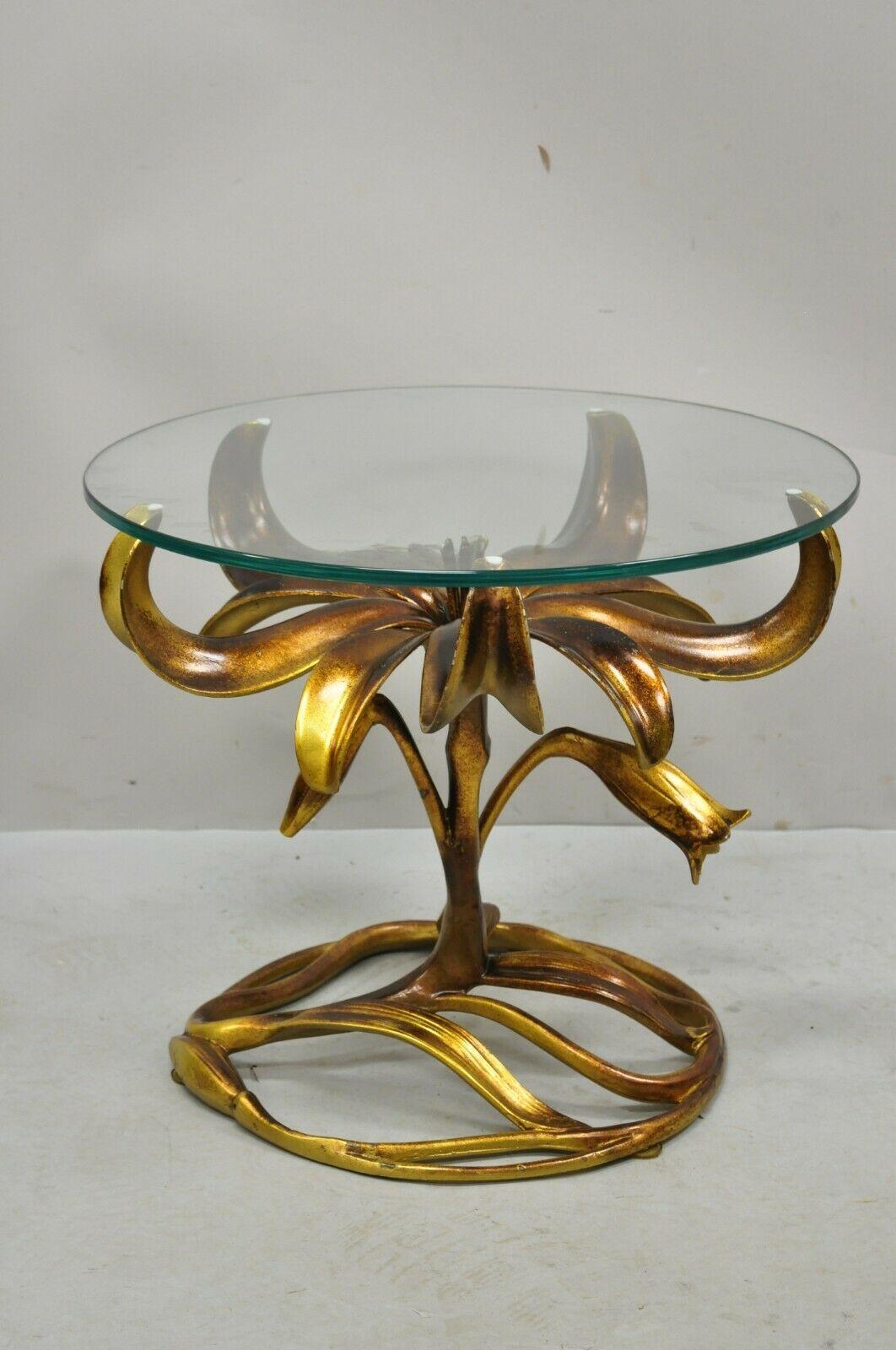 Arthur court gold gilt round glass top lily flowers side table. Item features cast aluminum gold gilt lily flower base, round glass top, burnished gold finish. Circa mid-20th century. Measurements: 16.5