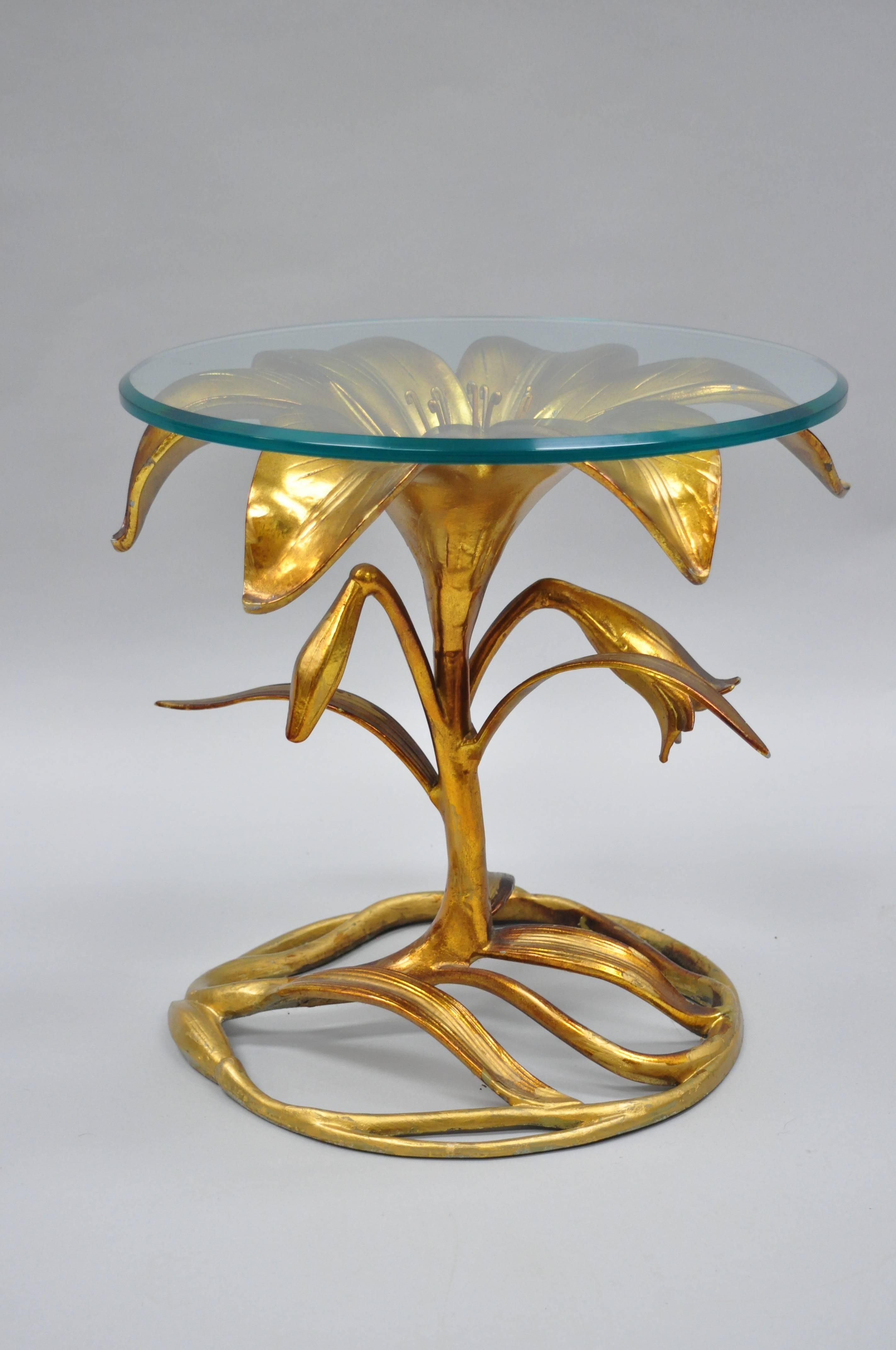 Vintage Arthur Court Hollywood Regency glass top gold lily leaf flower side table. Item features a gold finish, cast aluminium construction, beveled round glass top, great style and form, circa 1960s. Measurements: 17 H x 17