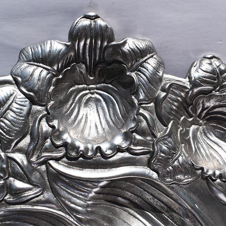 Silver Arthur Court deviled egg platter with floral detail and twelve wells. A beautiful serving platter for any table. This piece features scooped wells and carved orchid flowers. Arthur Court metal is handcrafted and does not require polishing