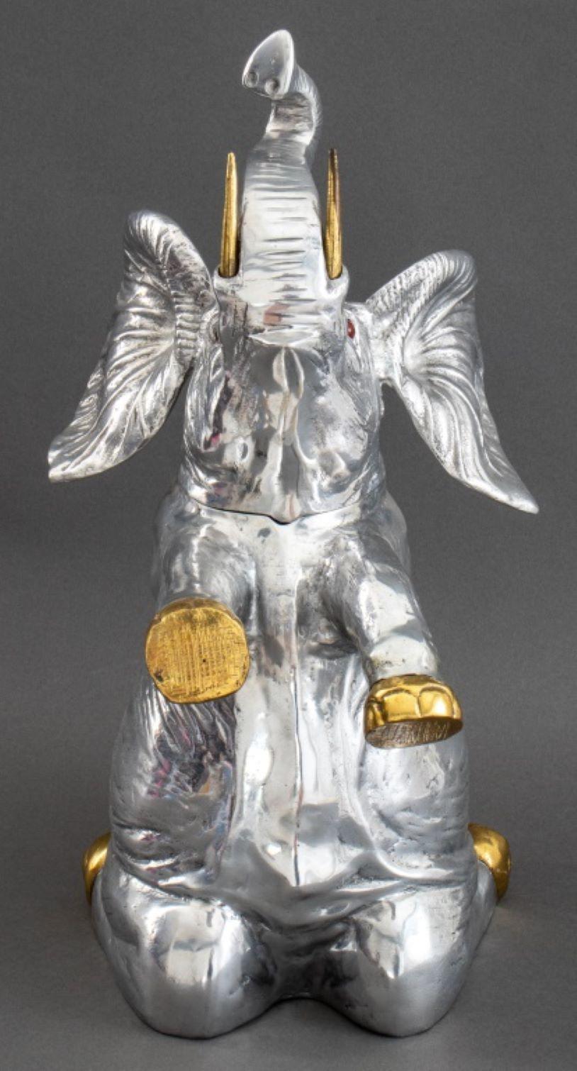 Arthur Court Silvered and Gilded Elephant Form Ice Bucket, the hinged head in the form of the elephant's head with ears wide, above a kneeling body with trunk raised. 21