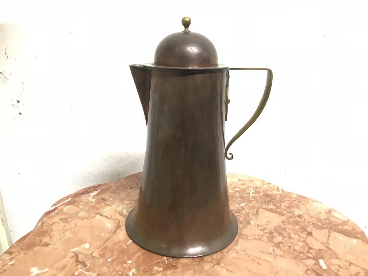 Arthur Dixon, designed for Birmingham guild of handicrafts.
An Arts & Crafts copper and brass jug and lid with rat tail handle.
Stamped 