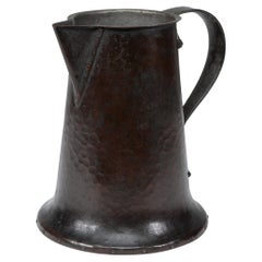 Arthur Dixon for the BGH. An Arts & Crafts hand-hammered copper jug
