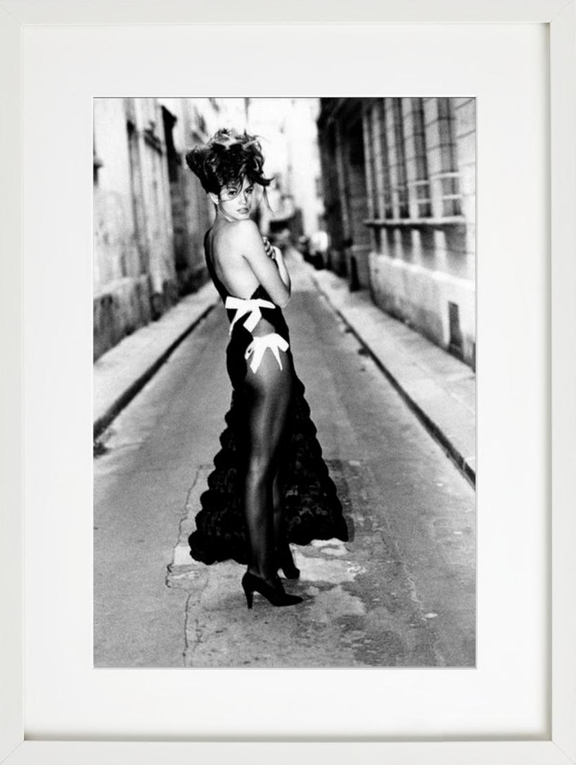 Cindy Crawford - in revealing black gown in a street, fine art photography, 1990 - Contemporary Photograph by Arthur Elgort