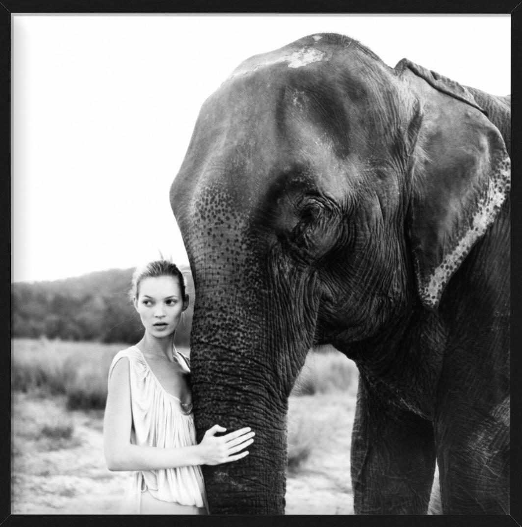 Kate Moss in Nepal II - portrait next to an elephant, fine art photography, 1994 - Black Black and White Photograph by Arthur Elgort