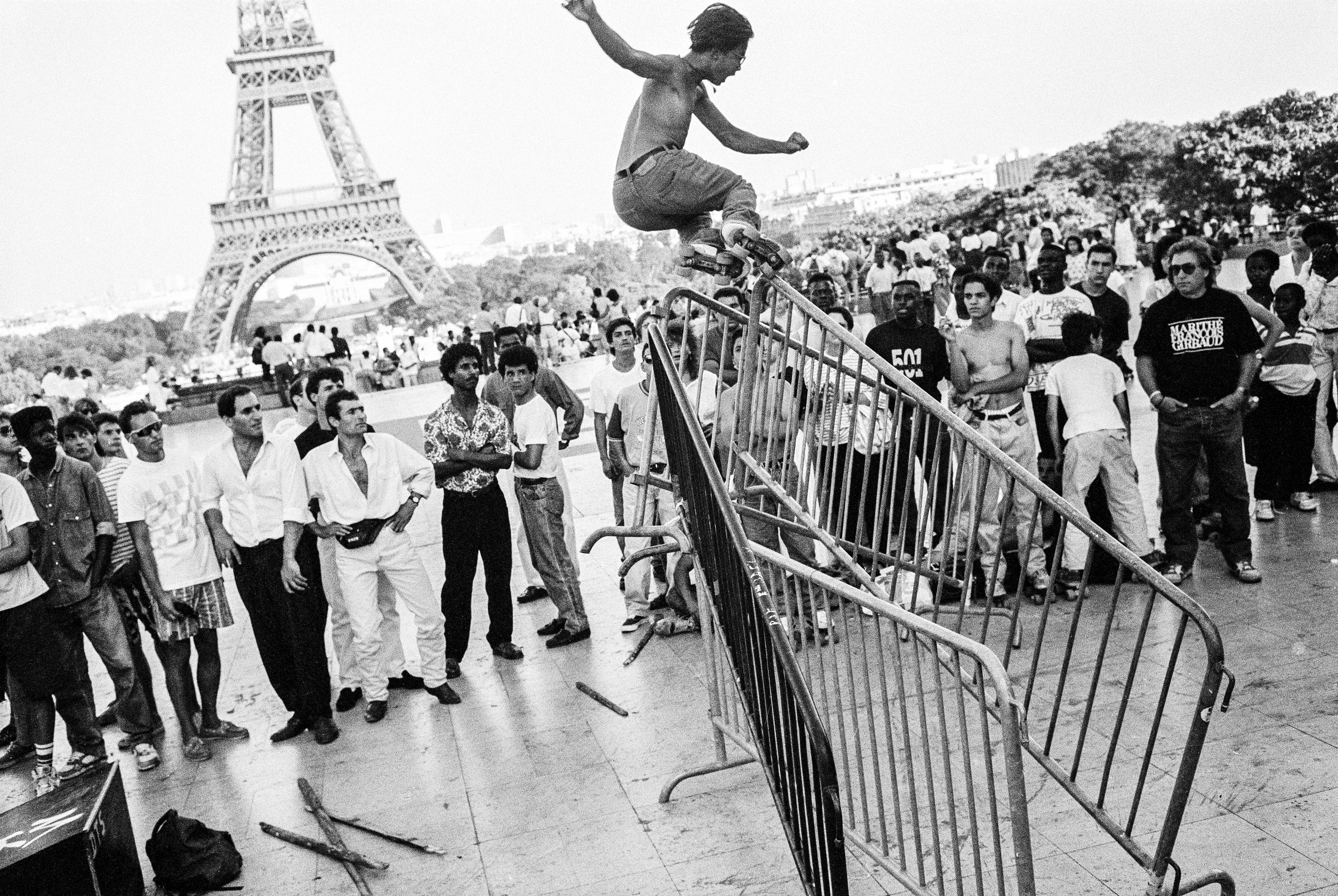 Skaters at the Eiffel Tower, Paris - Photograph by Arthur Elgort