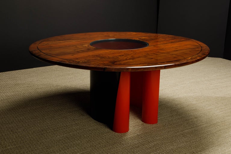This exquisite dining table (or monumental center table) by Arthur Espenet Carpenter, signed by the artist underneath: 'Espenet 8706', dating this work to 1987, features a monumental solid Walnut with Rosewood inlay top over a red and black sculpted