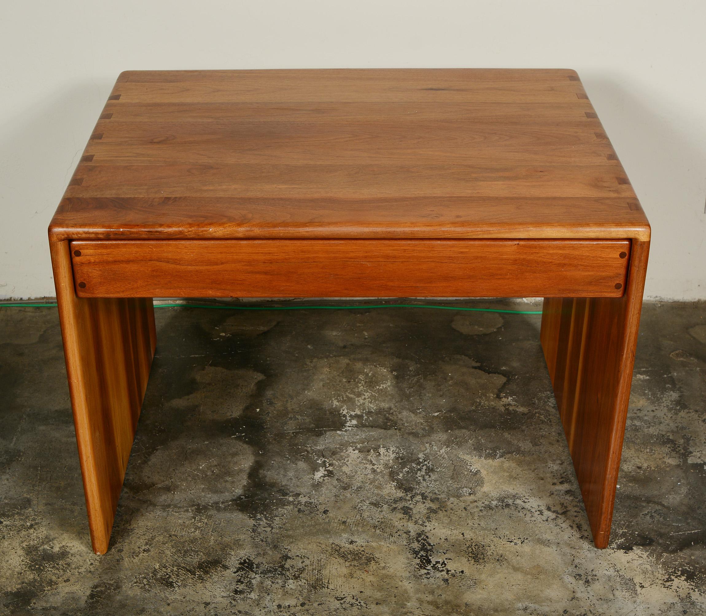 Side table in walnut by Arthur Espenet Carpenter, (1920-2006). This table has a single drawer below the top. The solid walnut sides and top are joined with dovetail joints. The runners for the drawer are visible on the back of the drawer and become
