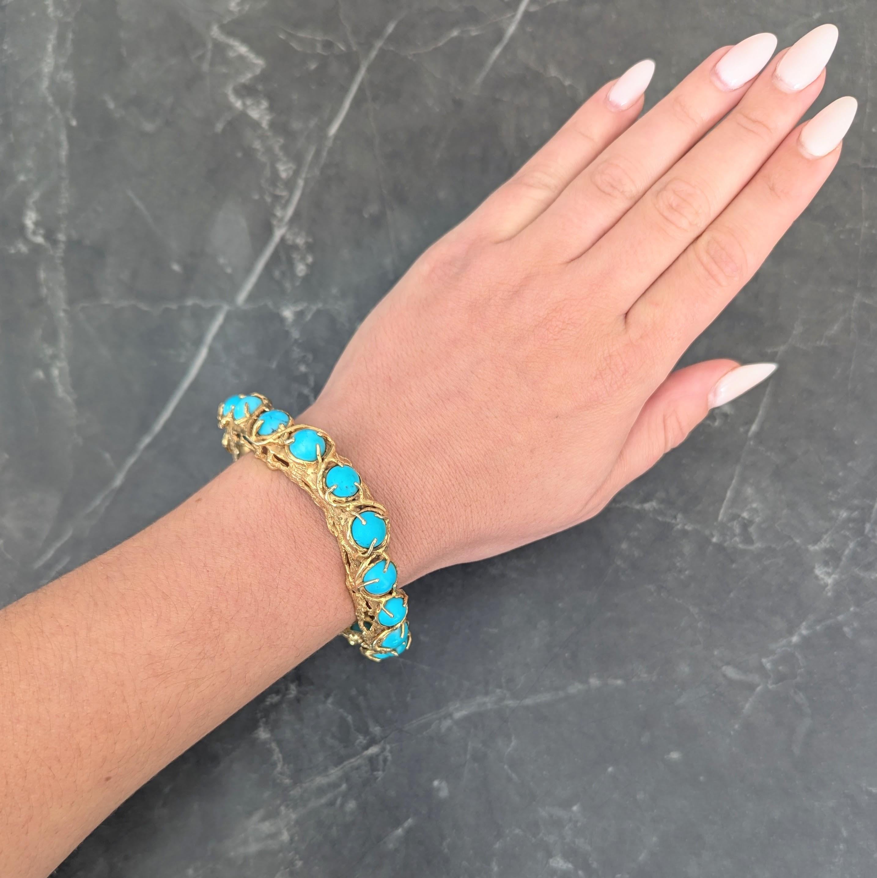 Designed as a domed round bangle with dimensional organic motif
With by biomorphic open work and grooved texture
Featuring 8.0 to 10.0 mm round turquoise cabochons
Set with tendril prongs in grooves fully around bangle
Opaque light blue to bluish