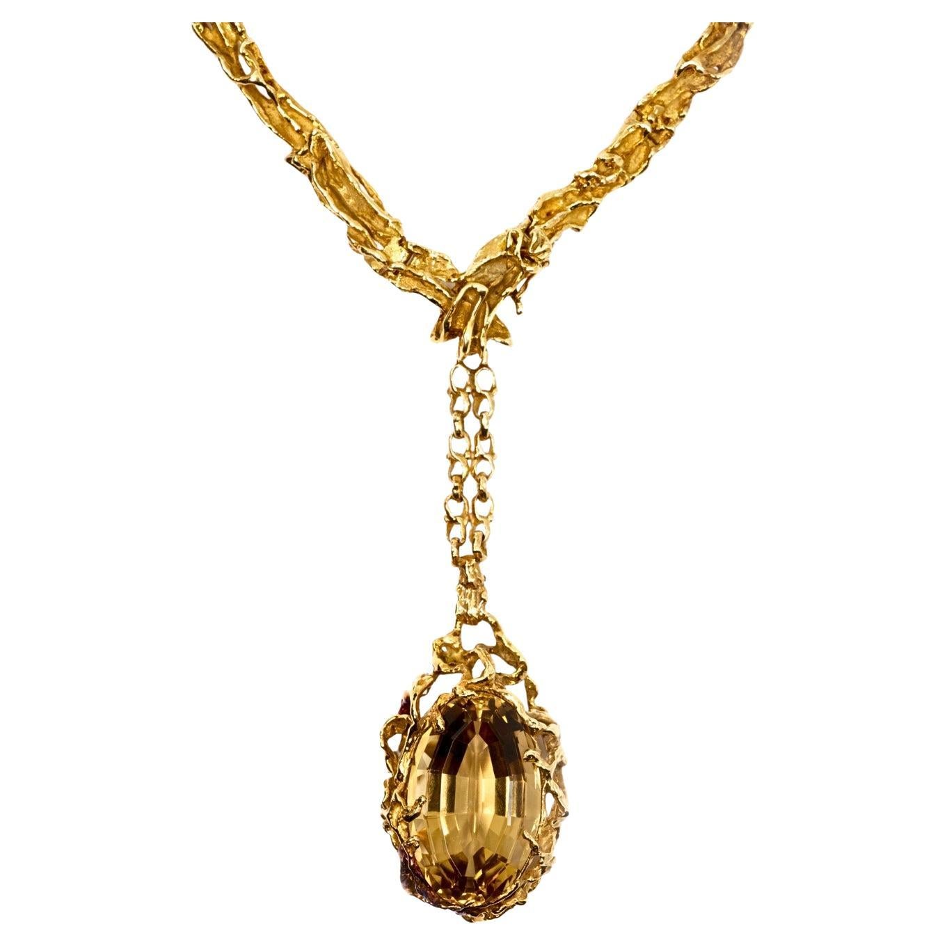 This one-of-a-kind citrine and 18 karat yellow gold necklace with a detachable pendant, designed by Arthur King, is the epitome of Jet-Set cool.

This pendant necklace by Arthur King was made in the United States in the 1970s and embodies King’s