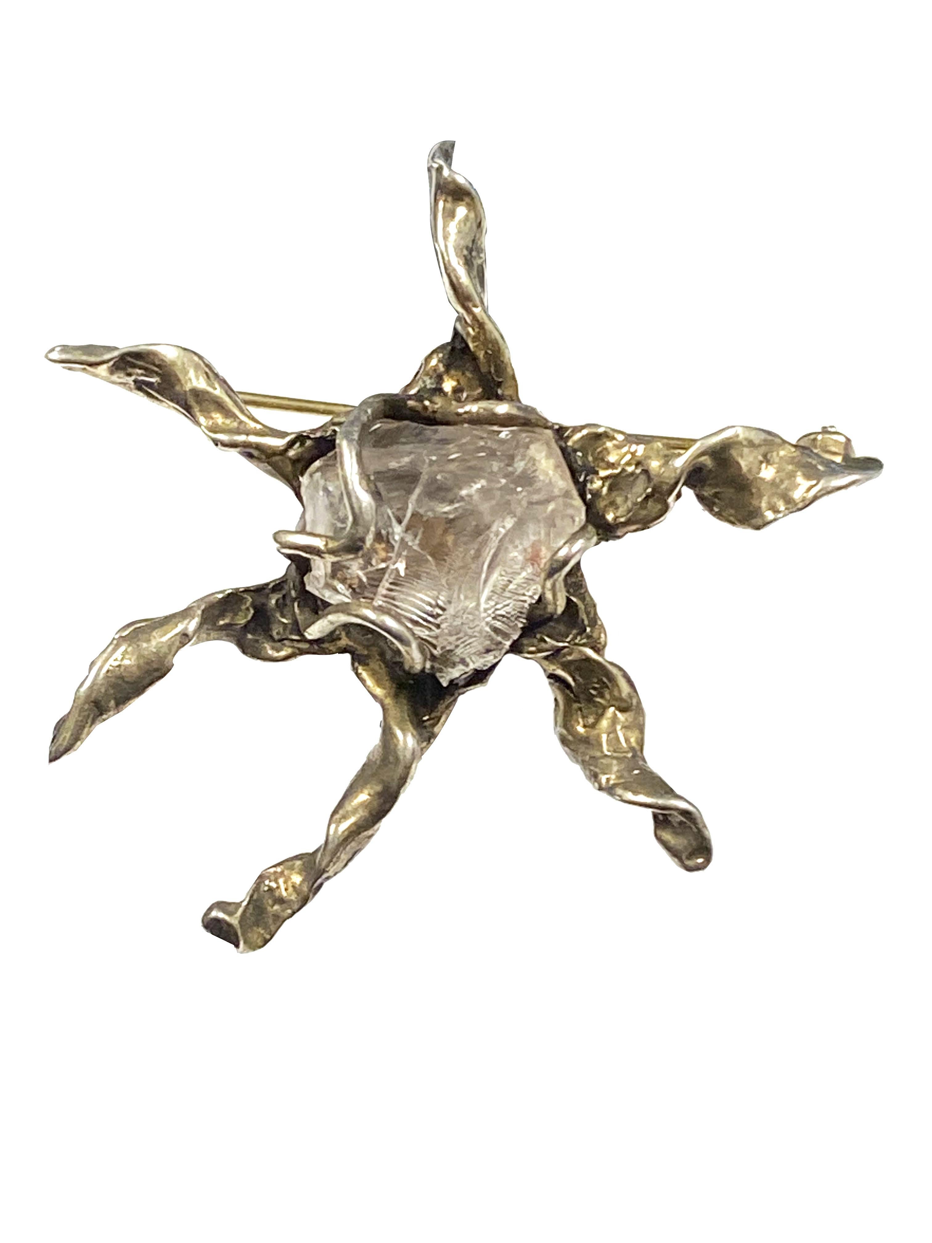 Circa 1970 Arthur King Mid Century Star shaped Sterling Silver Brooch, measuring 2 inches in diameter and centrally set with a Clear Rock Crystal. 