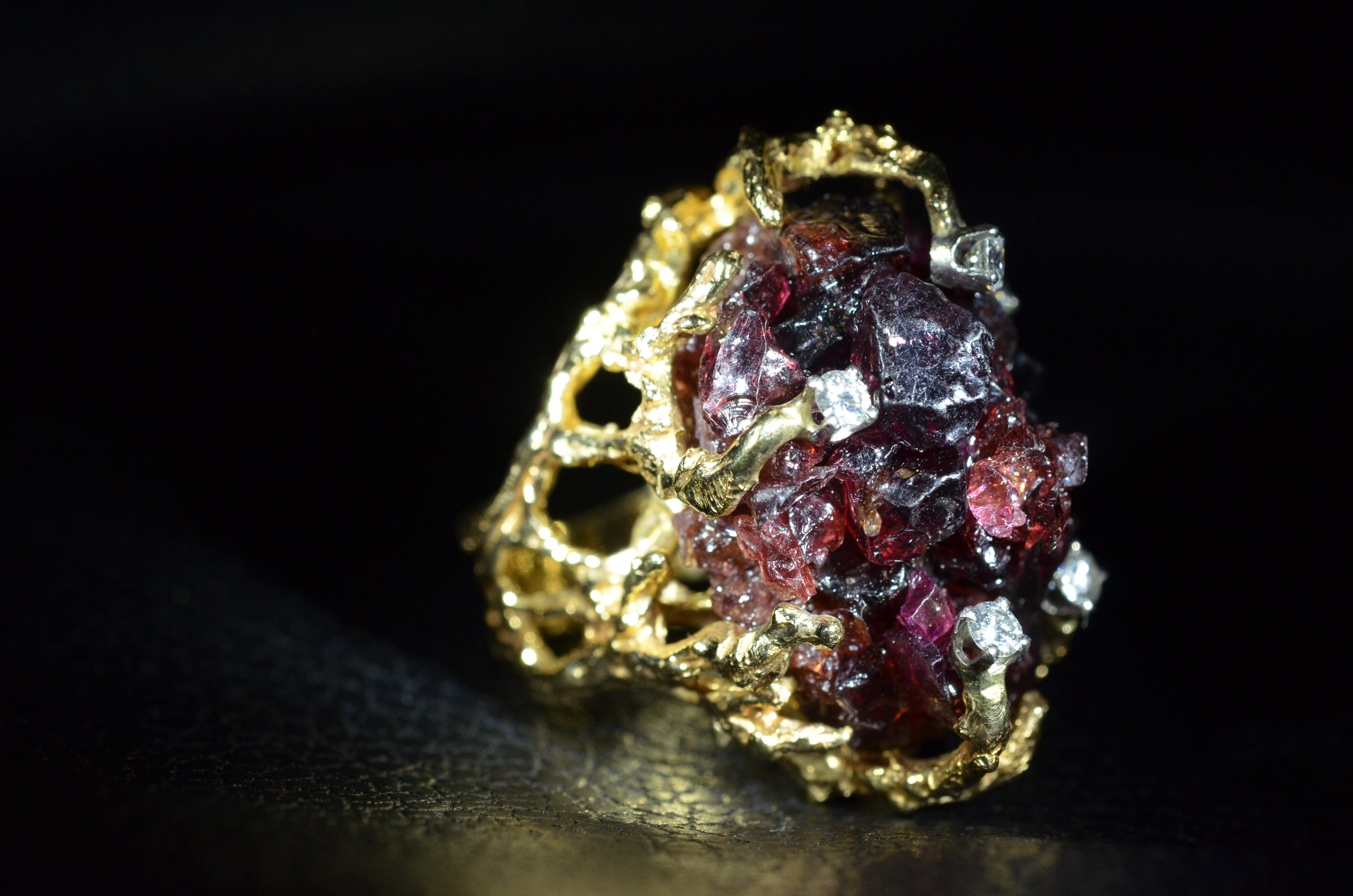 Arthur King Style Retro Garnet cluster and Diamond Ring in 14 karat yellow gold.  This modernist free form features a center cluster of garnets and diamonds sprinkled throughout. 