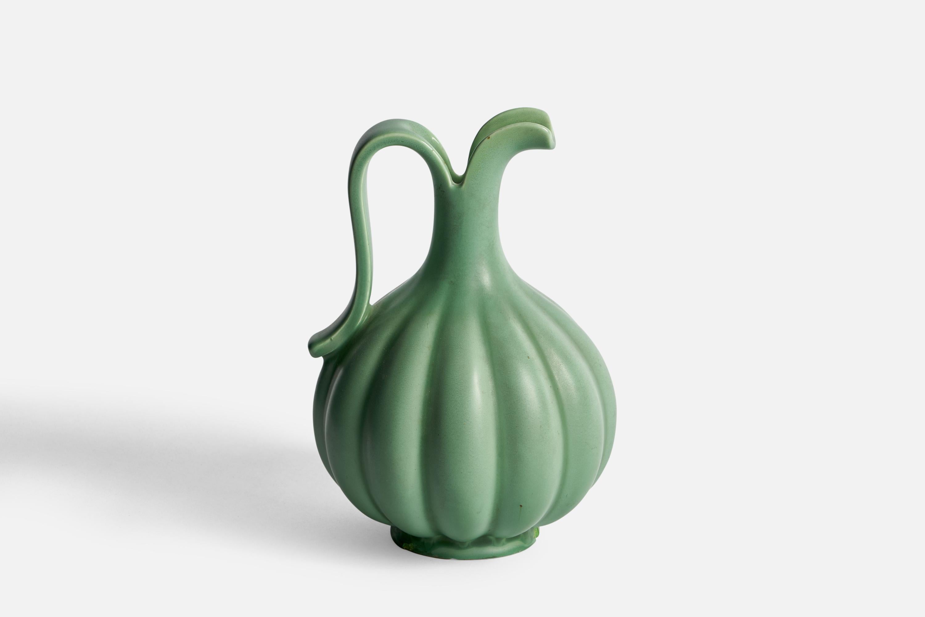 A fluted green-glazed ceramic pitcher designed by Arthur Percy and produced by Gefle, Sweden, 1930s.