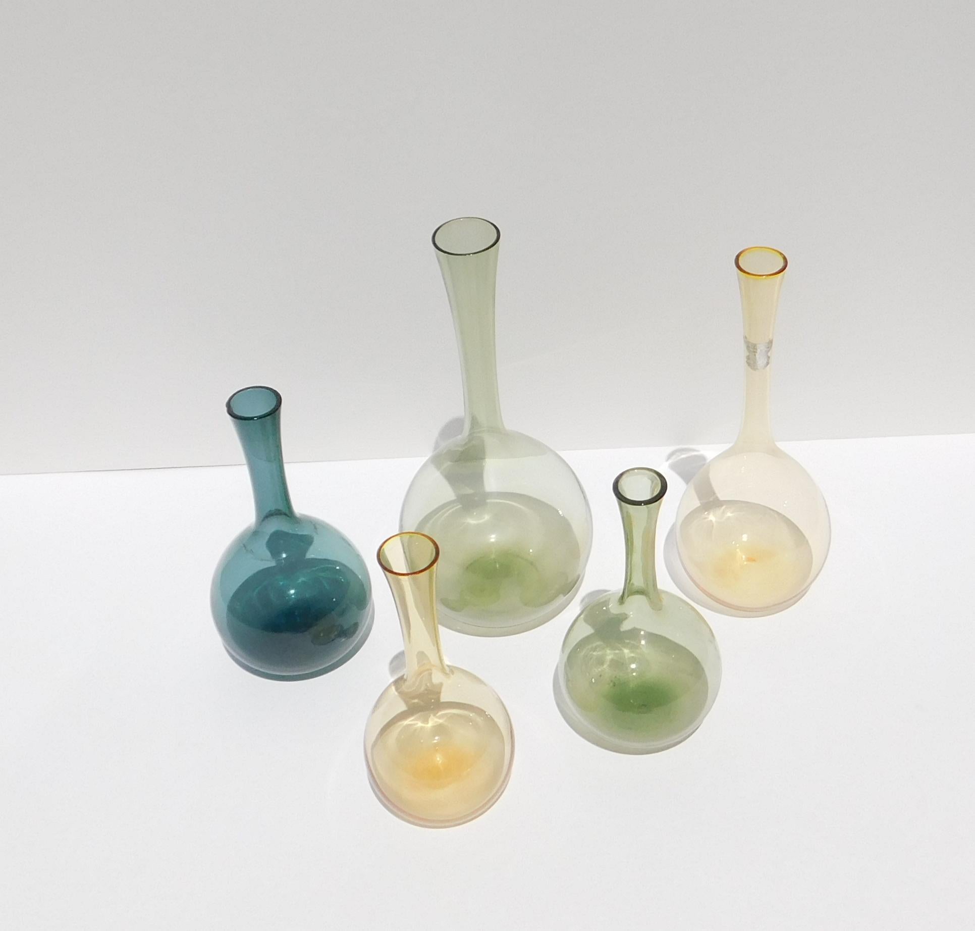 Set of 5 various sized Swedish glass bottles made by Gullaskruf.
Designed by Arthur Percy, circa 1950s.

The bottles measure largest to smallest:
Green: 7 1/4