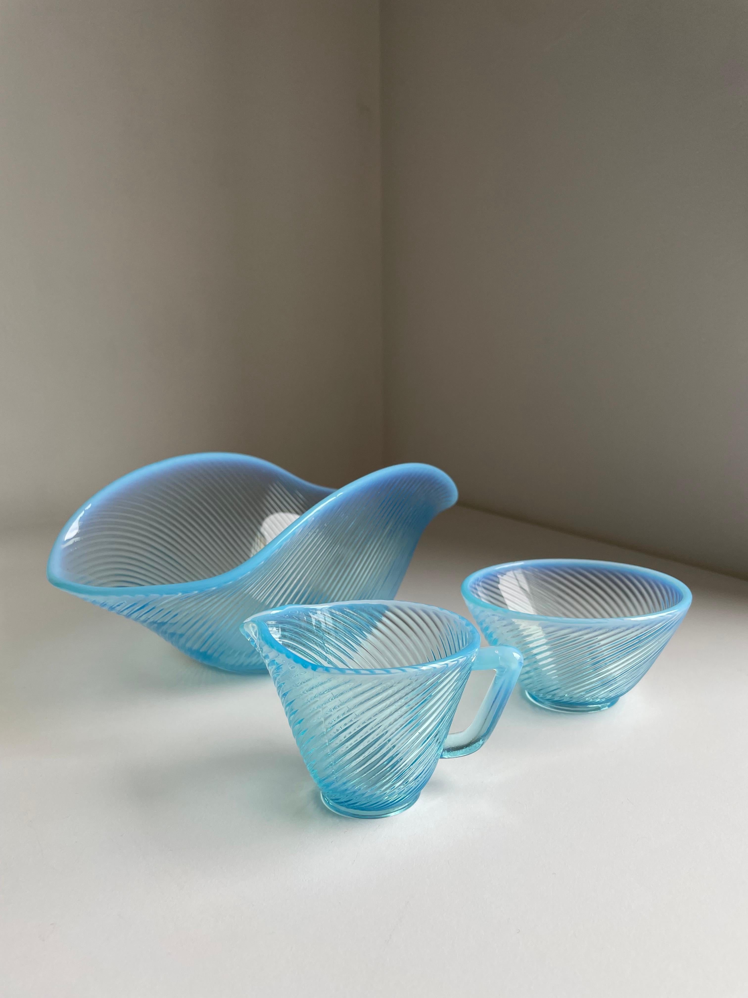 Swedish midcentury modern light blue glass milk and sugar set. Delicate sky blue tinted textured glass bowl from the Reffla series (reffla is Swedish for grooves) designed by Arthur Percy in 1952. White and light blue opalescent glass constitutes