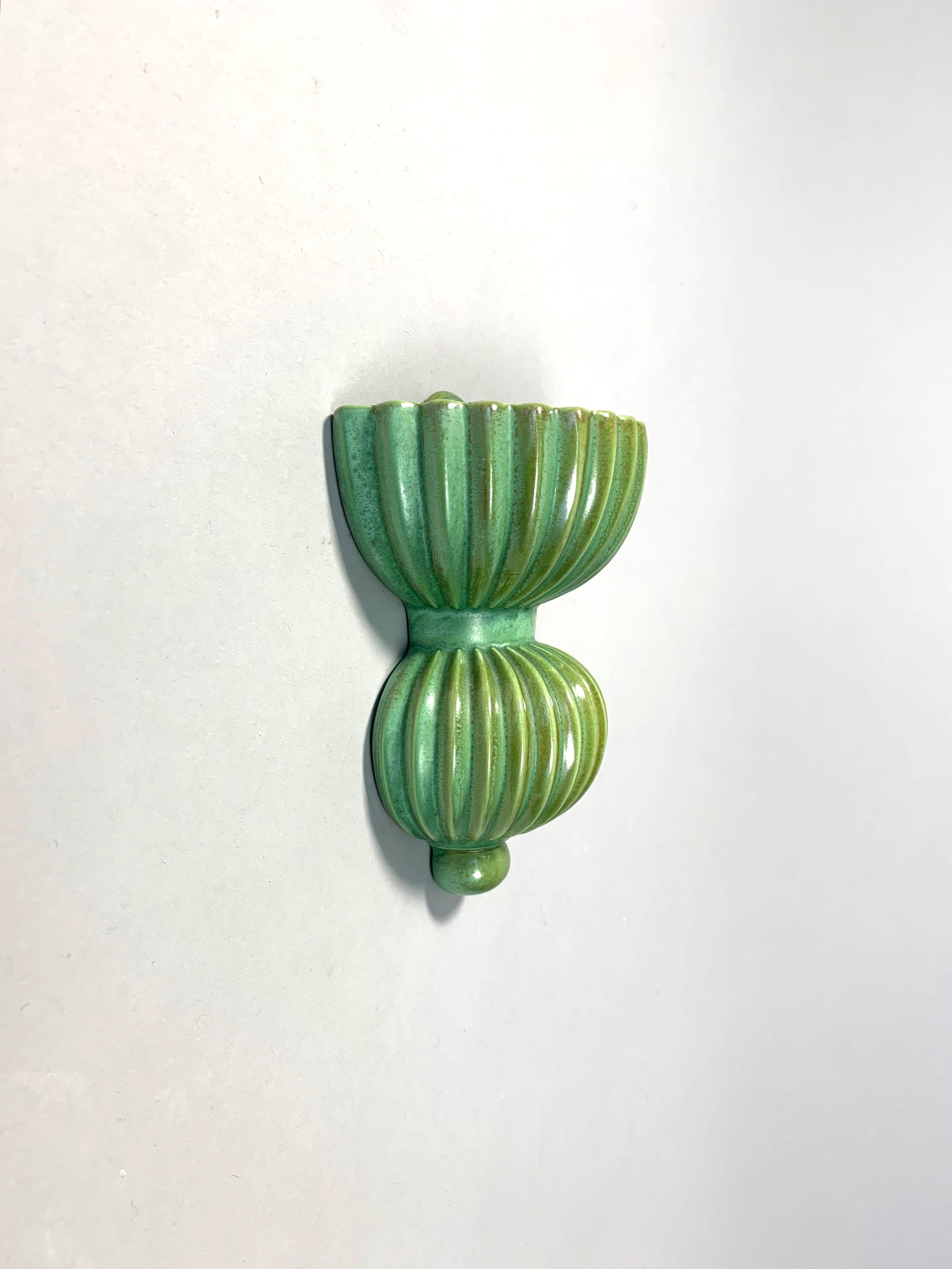 Rare small wall hung vase designed by the artist and designer Arthur Percy in ‚Celadon’ green hand-glaze for Gefle porcelain factory in Sweden in the 1930s.

Remains the original factory stamp on the back, can be dated between