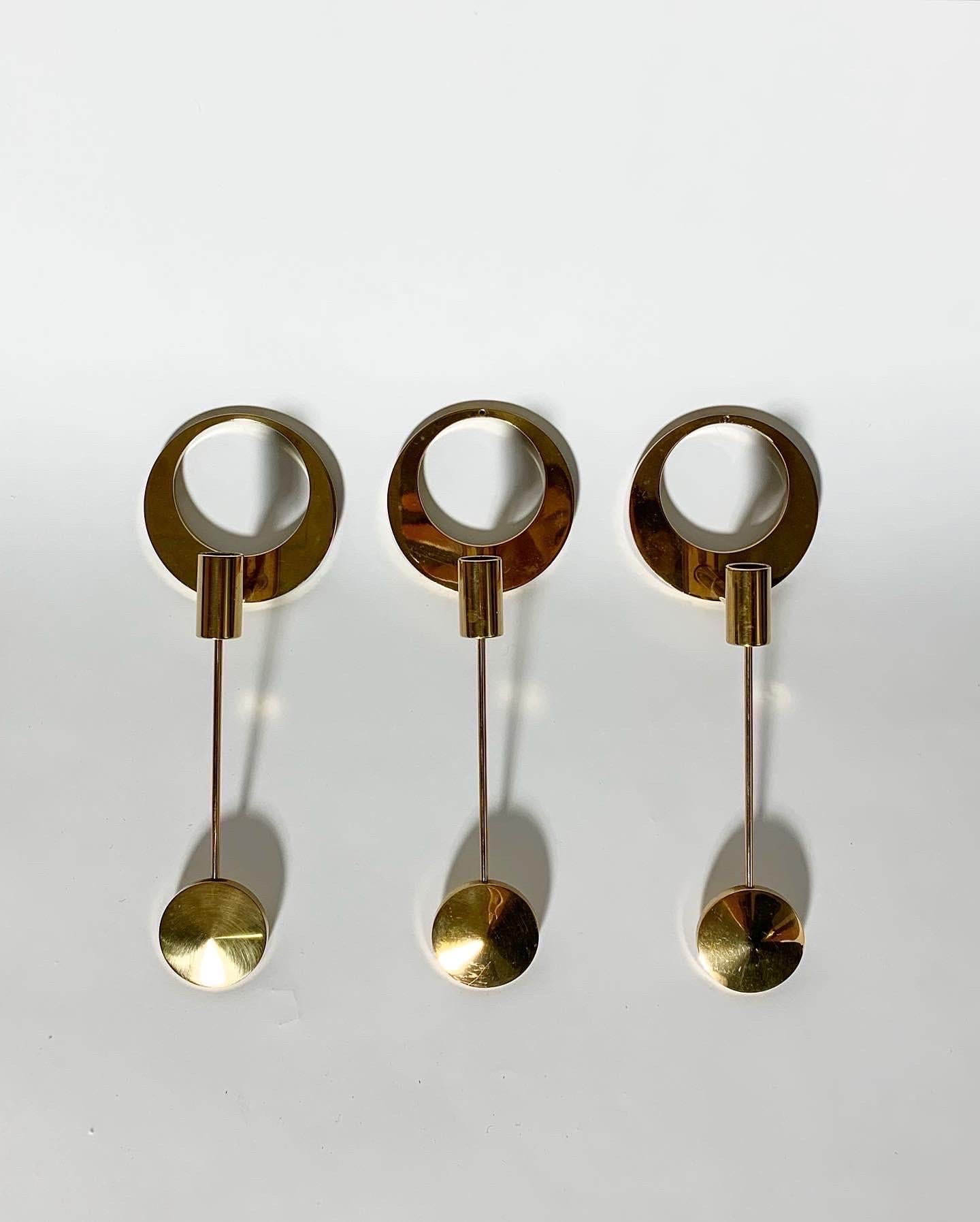 We currently have seven pieces available, one of them without a hole in top brass piece to mount it with a nail. 

Arthur Pettersson wall mounted crescent moon candle holders in solid brass, hand-crafted in Kolbäck, Sweden in the 1960s.

Brass