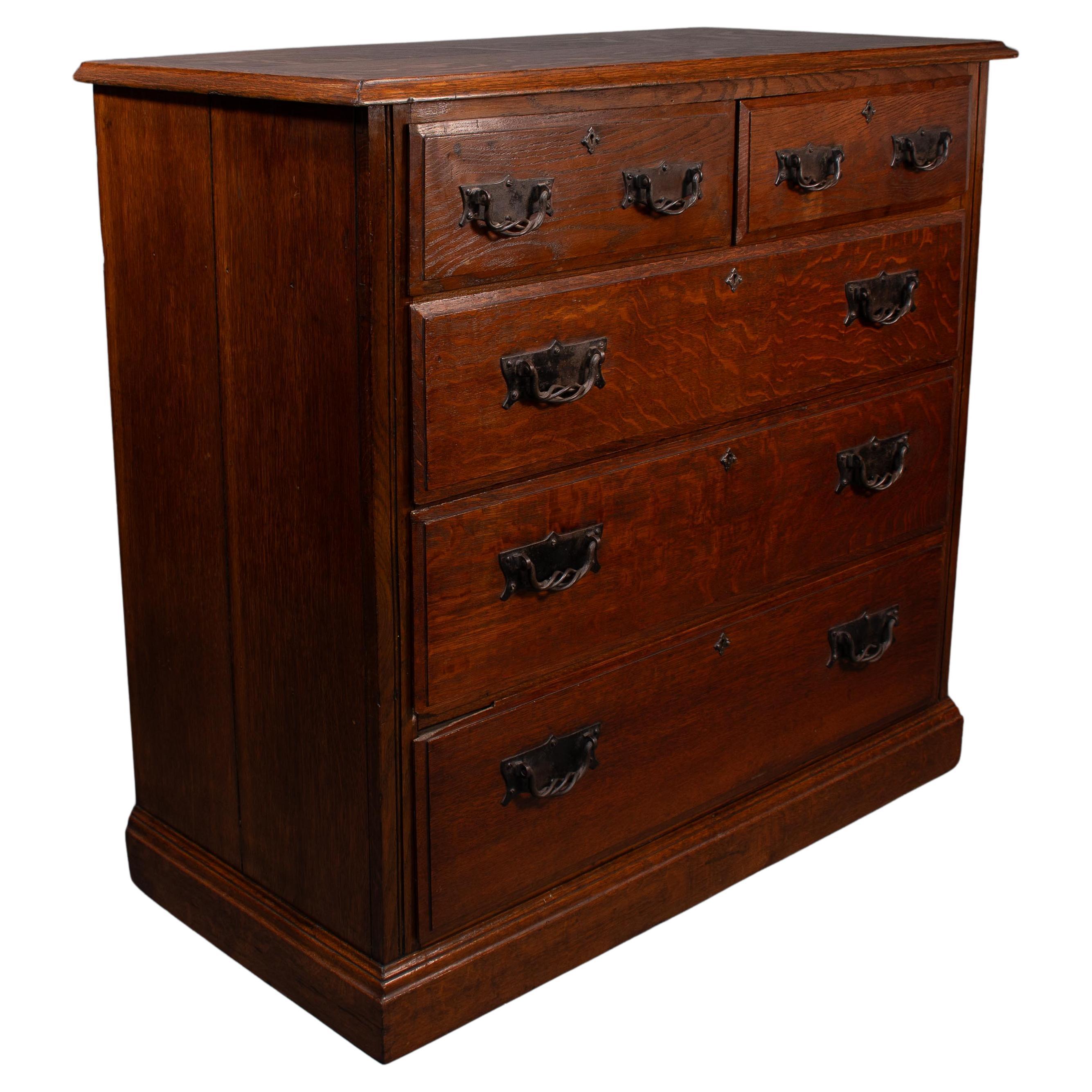 Arthur Simpson of Kendal. Arts & Crafts oak chests of drawers with iron handles.