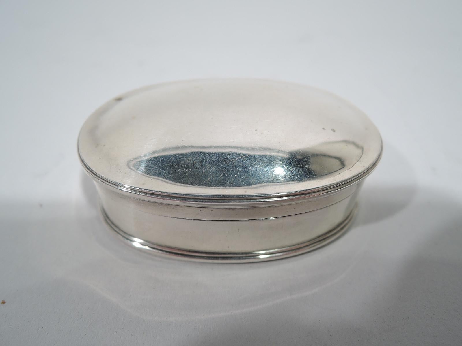 Craftsman sterling silver trinket box. Made by Arthur Stone in Gardner, Massachusetts, ca 1920. Oval with straight sides and molded base. Cover gently curved with molded rim. Gilt interior. Fully marked including silversmith’s initial T for Herbert