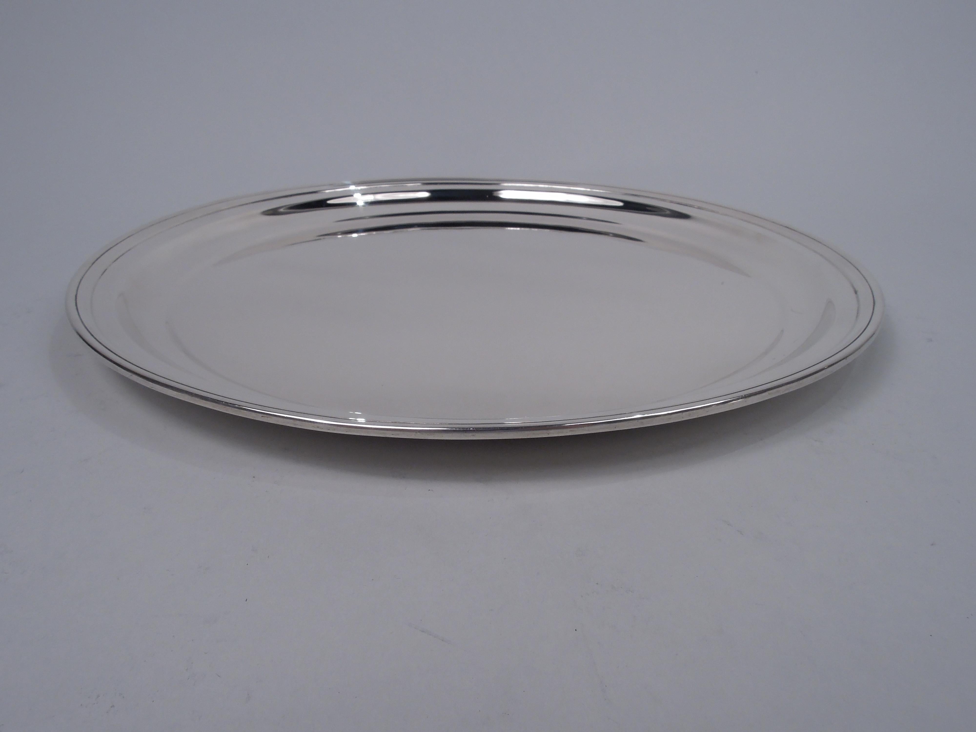 Modern sterling silver tray. Made by Arthur Stone in Gardner, Mass., ca 1930. Round well with curved sides, tapering shoulder, and molded rim. Fully marked including maker’s stamp and craftsman’s initial T for Herbert A. Taylor, who was active from