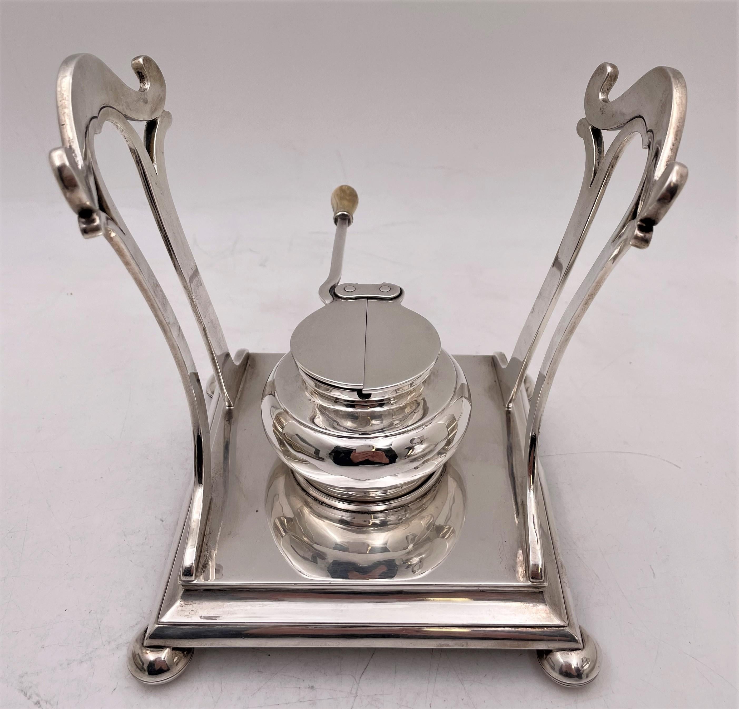 Arthur Stone, hand hammered sterling silver kettle on stand with burner in Arts & Crafts style from the early 20th century. This extremely elegant ensemble exhibits the attention to geometric, curvilinear design typical of the Arts & Crafts
