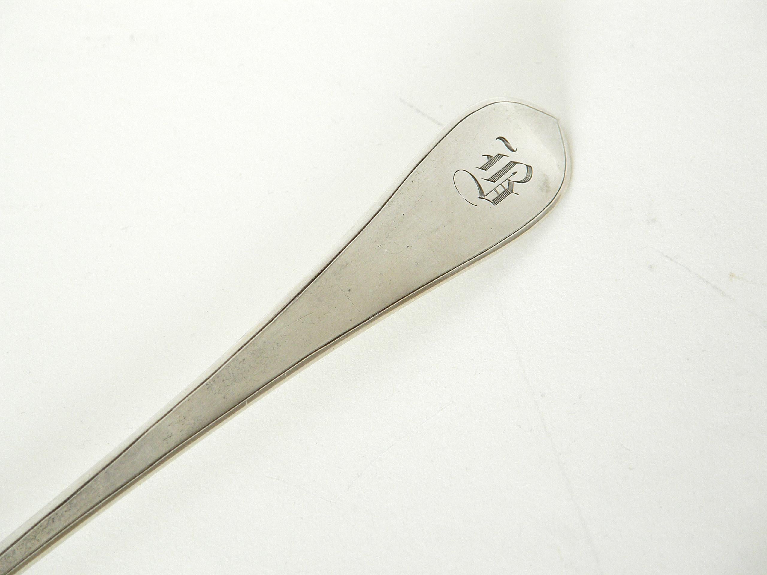 This sterling silver long spoon, claret ladle, or cocktail stirrer was made at the Arthur Stone workshop. It has an elegant line with a teardrop shaped bowl and a handle that tapers to a point. It has an incised line that accents the handle edges