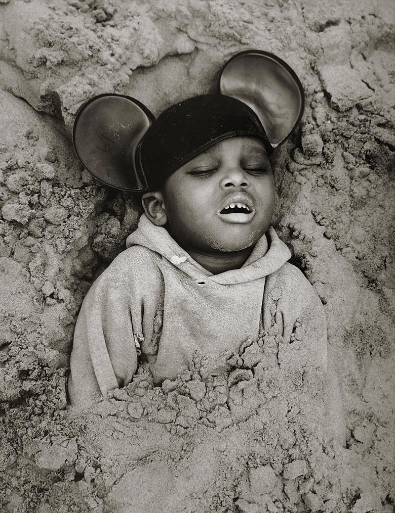 Arthur Tress Black and White Photograph – Boy in Mickey Mouse Hut, Coney Island, New York