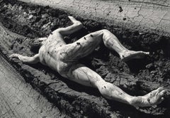 Road Kill (a nude male lies in the deep ruts of a muddy curved trail)