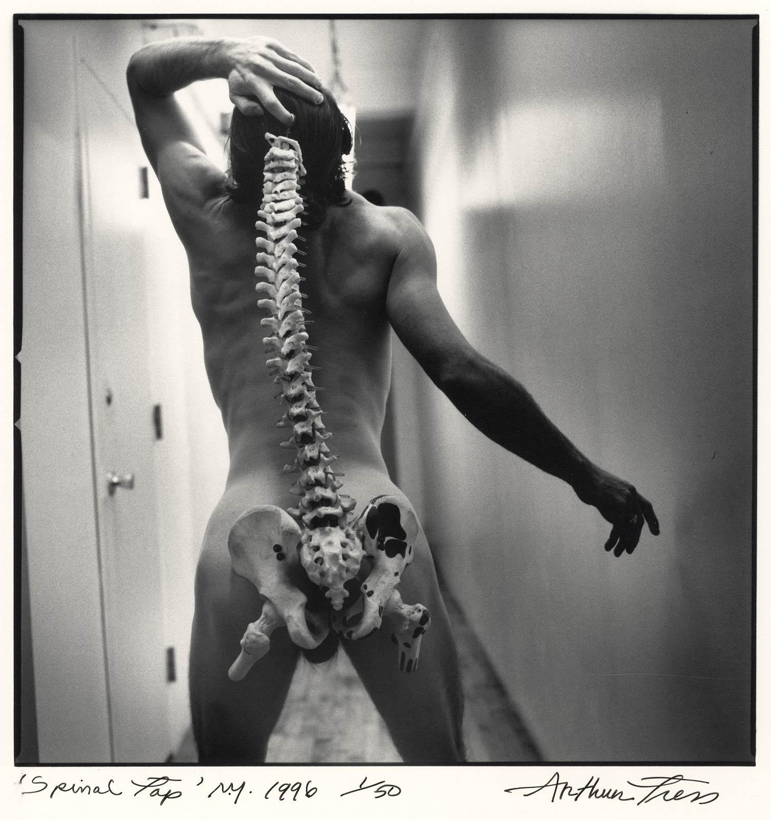 Spinal Tap (nude male standing with skeleton of actual spinal column) - Contemporary Photograph by Arthur Tress