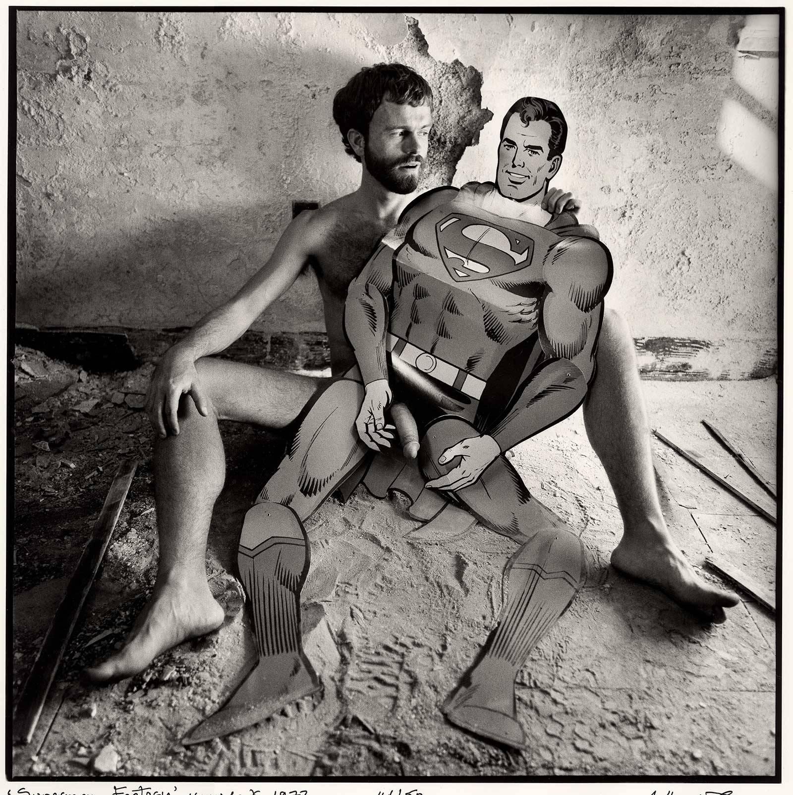 Arthur Tress Figurative Photograph - Superman Fantasy, New York (Male Nude fills the gap in super hero cutout figure)