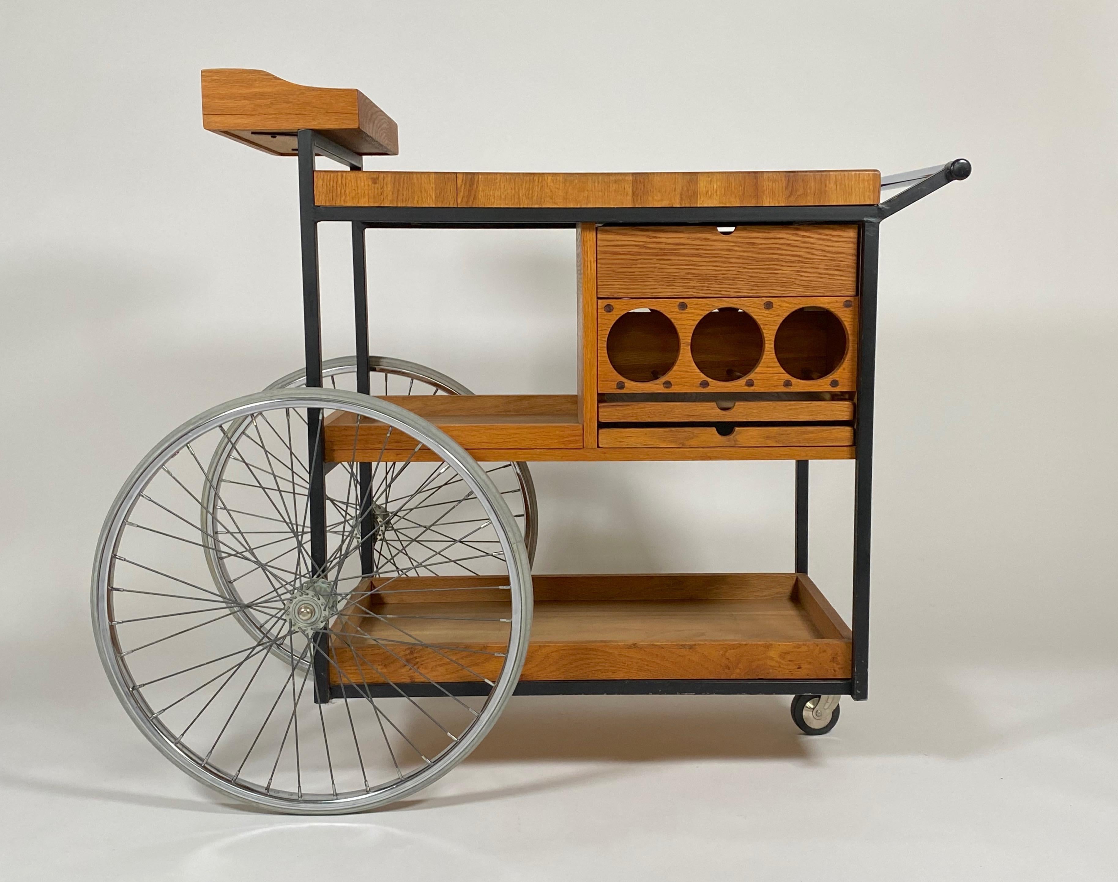 American designer Arthur Umanoff (1923-1985) serving / bar cart, constructed of an oak butcher block top, black lacquered metal frame, chrome and rubber wheels. The cart has three drawers for the storage of objects related to bar service and three