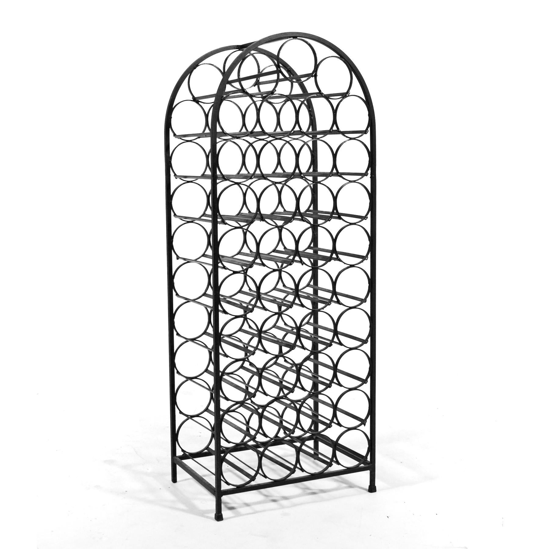 Ready to hold 39 wine bottles, this iron wine rack by Arthur Umanoff has a delightful curved top echoing the round shape of the bottle holders and a terrific graphic quality.

 