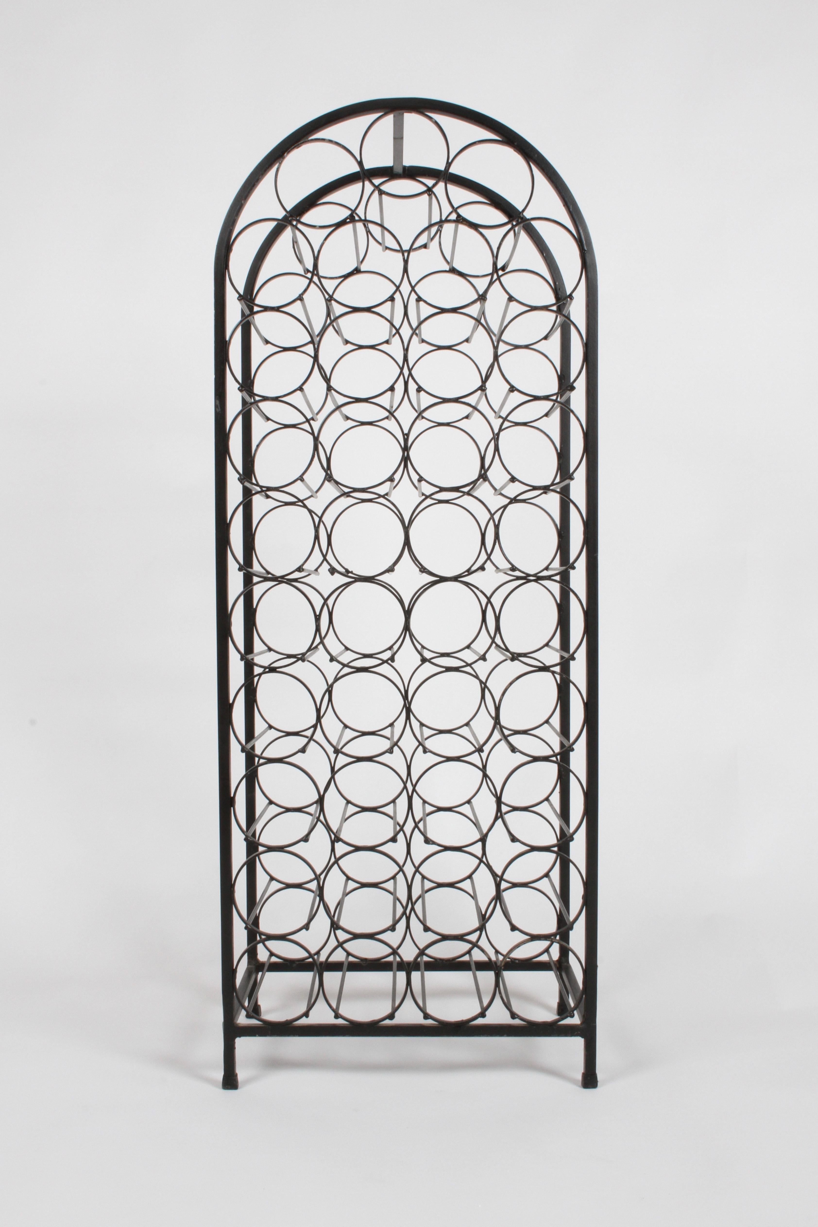 Mid-Century Modern Arthur Umanoff for Raymoor, black painted wrought iron free standing wine rack that holds
39 bottles. Minor wear to paint.