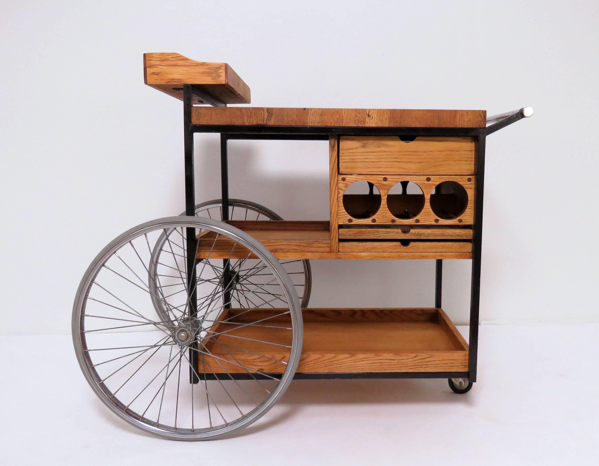 Bar cart or barbecue trolley, designed by Arthur Umanoff for David Morgan ca. late 1960s - early 1970s. Includes staved teak work surface for carving of meat, wine bottle storage, a deep drawer and two shallow drawers, and other storage areas. 