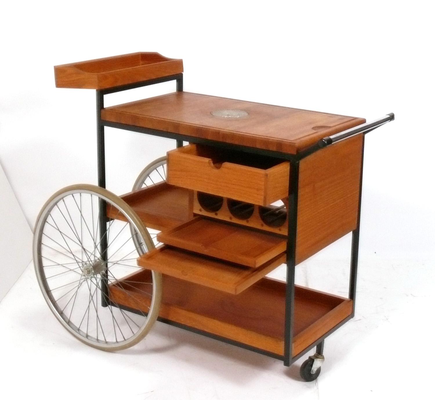 Clean Lined Organic Modern Bar Cart, designed by Arthur Umanoff, American, circa 1960s. It is a versatile size and can be used as a bar or serving cart in a living area, or as additional rolling storage in a home office. 